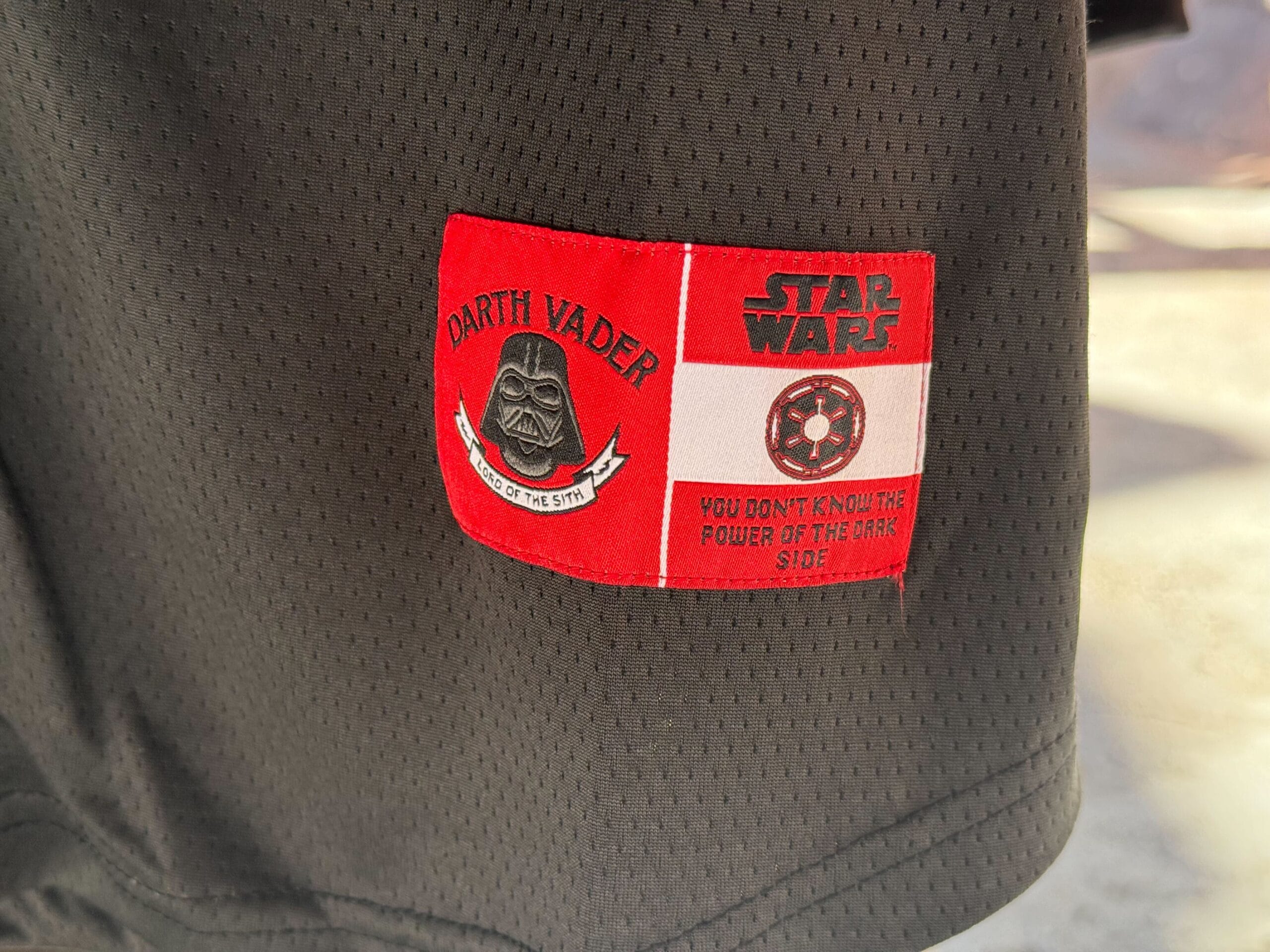 Close-up of Star Wars merch: black fabric with a red and white Darth Vader patch from Galaxy's Edge.