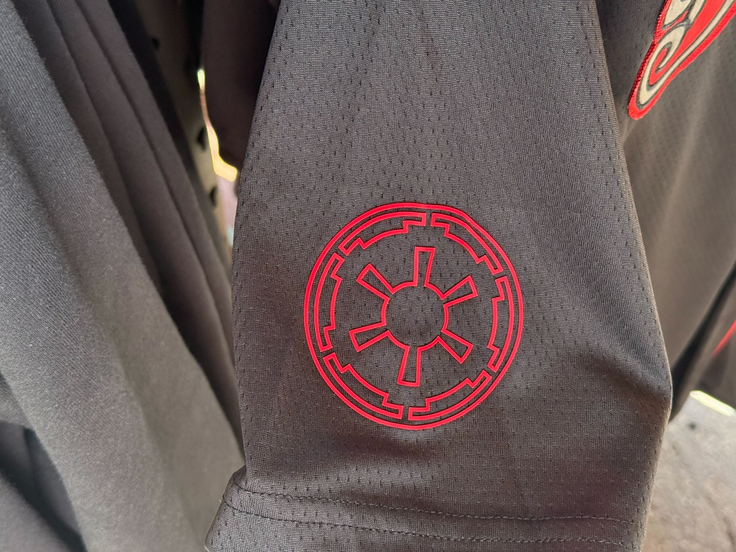 Black sleeve with a red Galactic Empire symbol, perfect Star Wars merch from Galaxy's Edge at Disneyland.