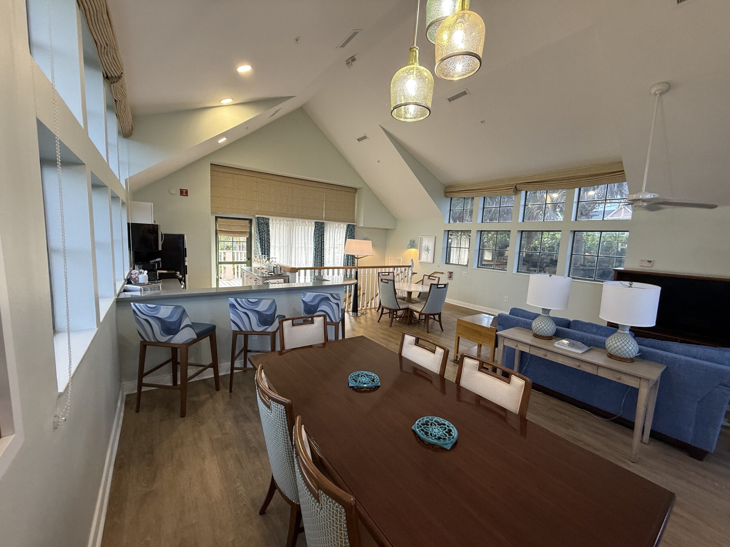Open-concept living and dining area at Disney's Vero Beach Resort 3 Bedroom Cottage, blue accents, modern decor, no castle view.