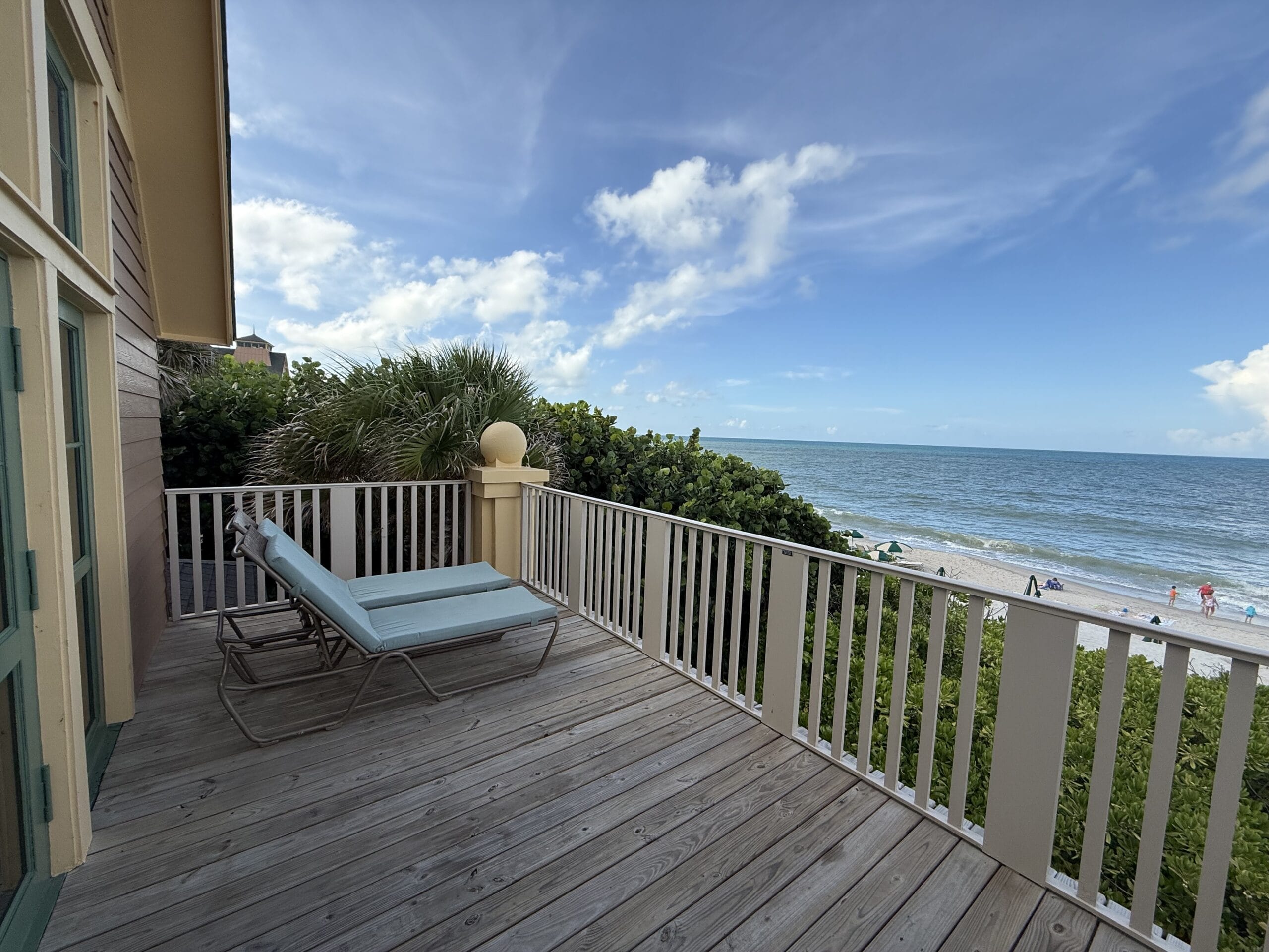 A wooden balcony at Disney’s Vero Beach Resort overlooks the ocean, evoking the seaside charm found at Disney’s resorts worldwide.