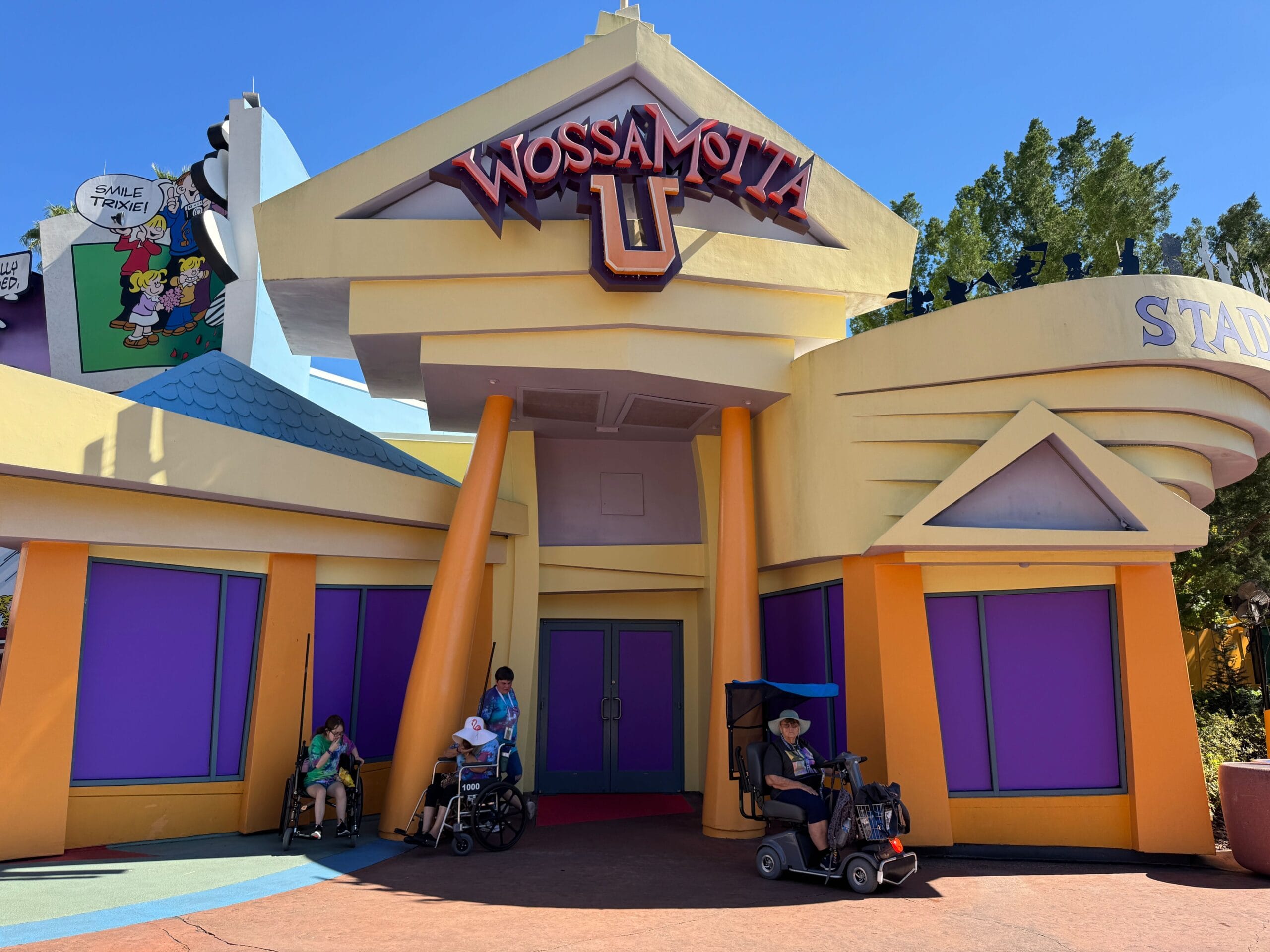 The exterior of the cartoonish "Wossamotta U" gift shop at Universal Islands of Adventure, with doors and windows blocked with solid purple panels.