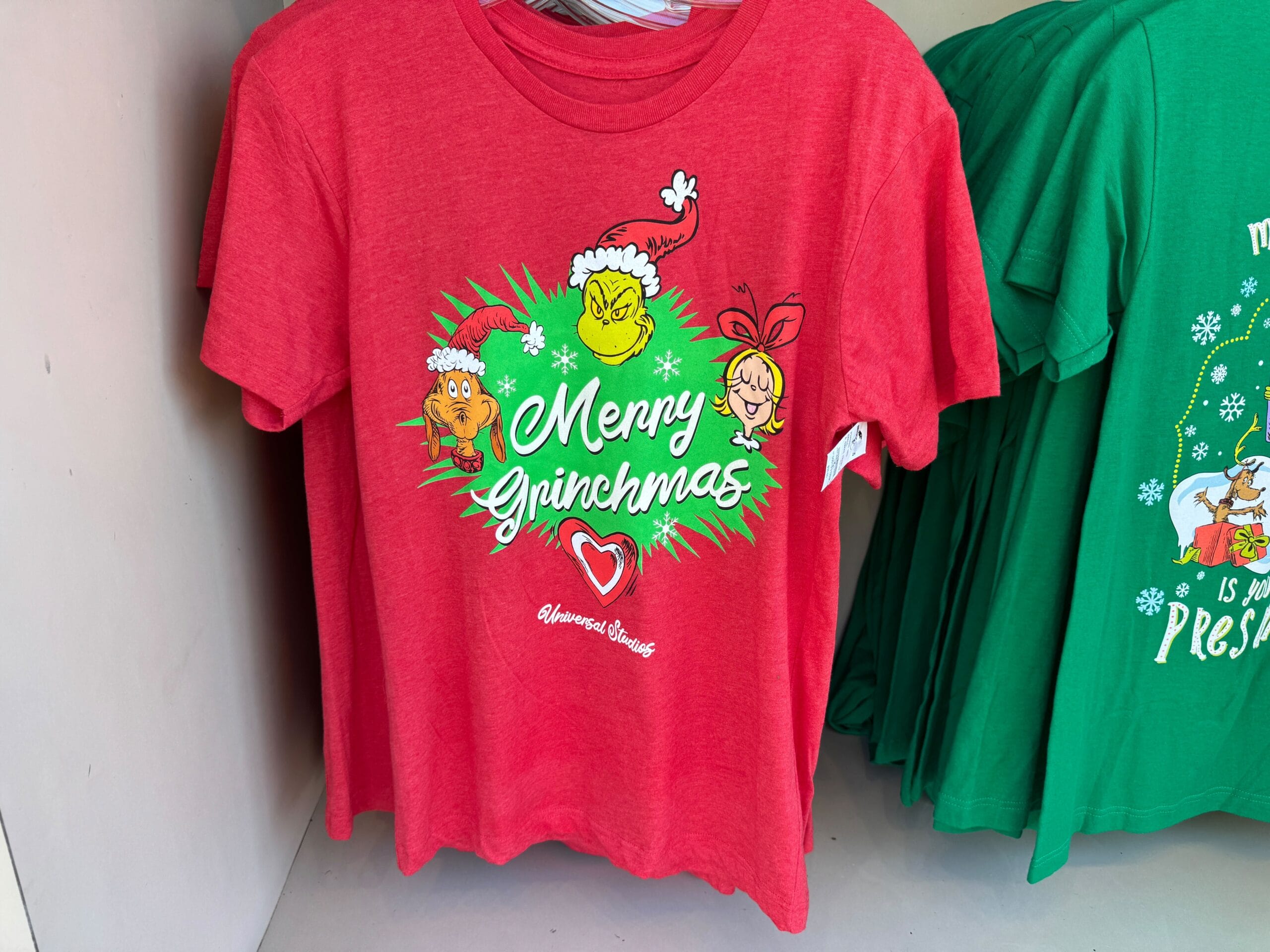 This red t-shirt shows Grinch, Max, and Cindy Lou Who. Unlike Disney castle shirts, it’s official Universal Orlando merch!