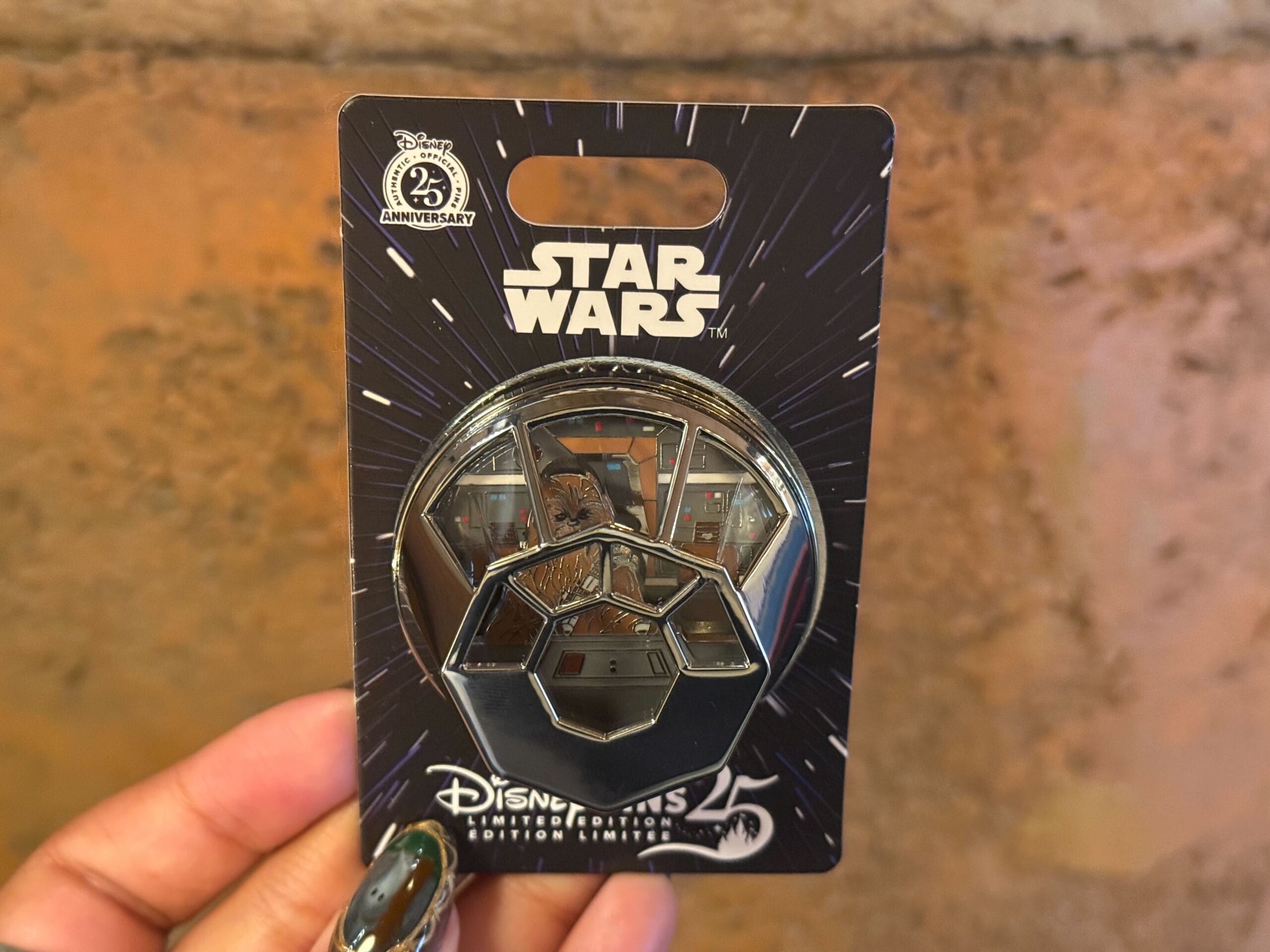 A three-dimensional pin depicts the Millennium Falcon cockpit with Chewbacca inside.