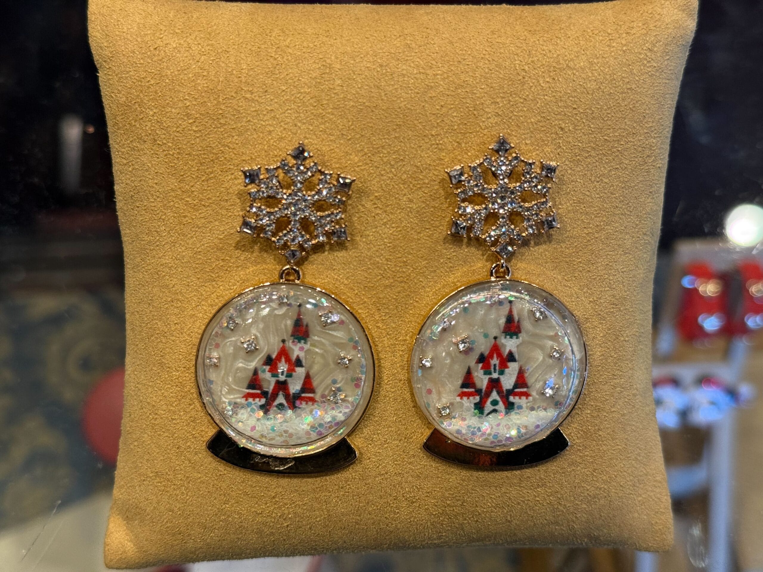 Festive earrings with snowflake tops and plaid Christmas tree snow globe charms, ideal for 2025 Disneyland holiday merch.