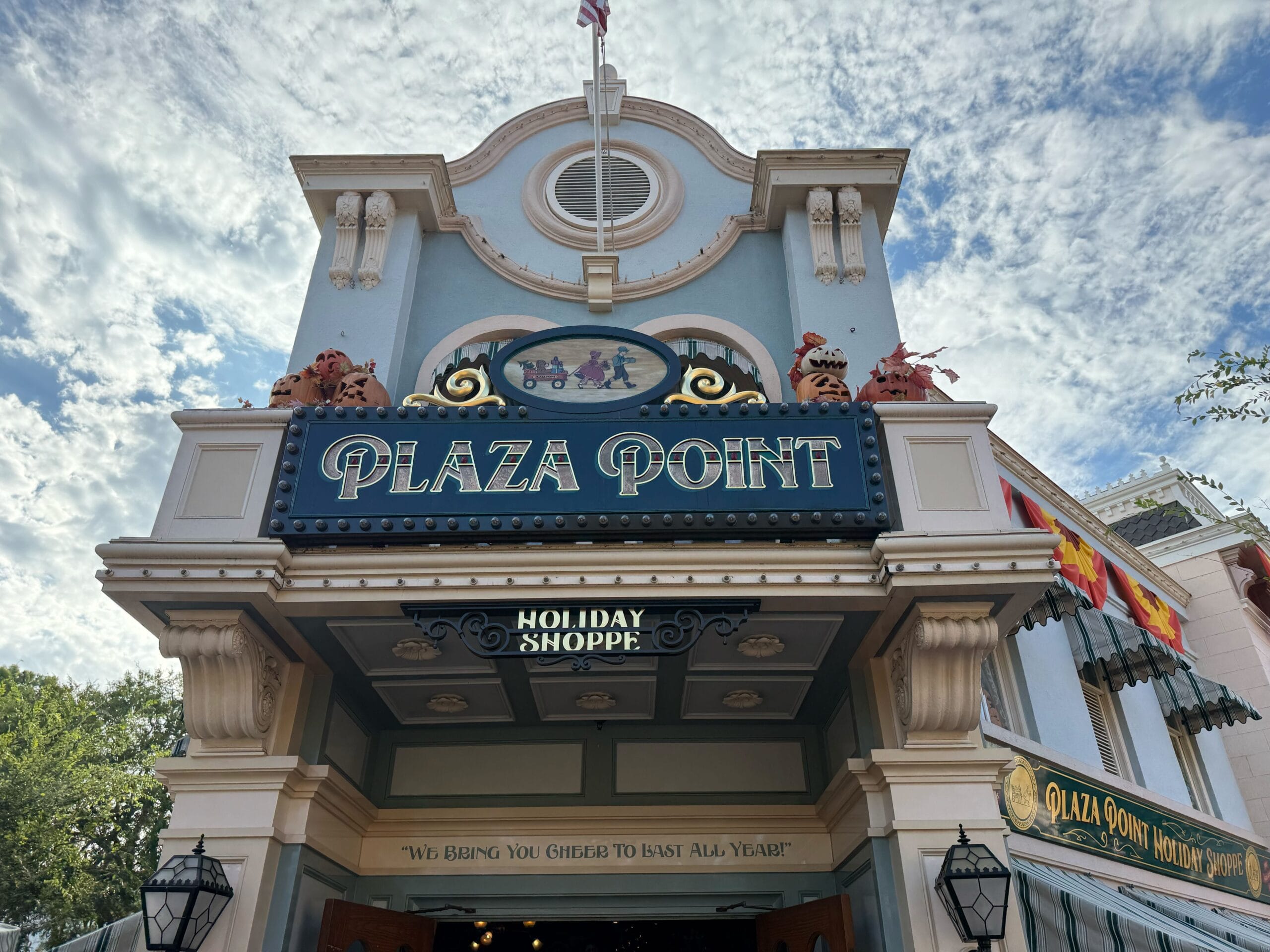 Plaza Point Holiday Shoppe decked in festive decor, showcasing 2025 Disneyland holiday merch near Main Street like classic castle shops.