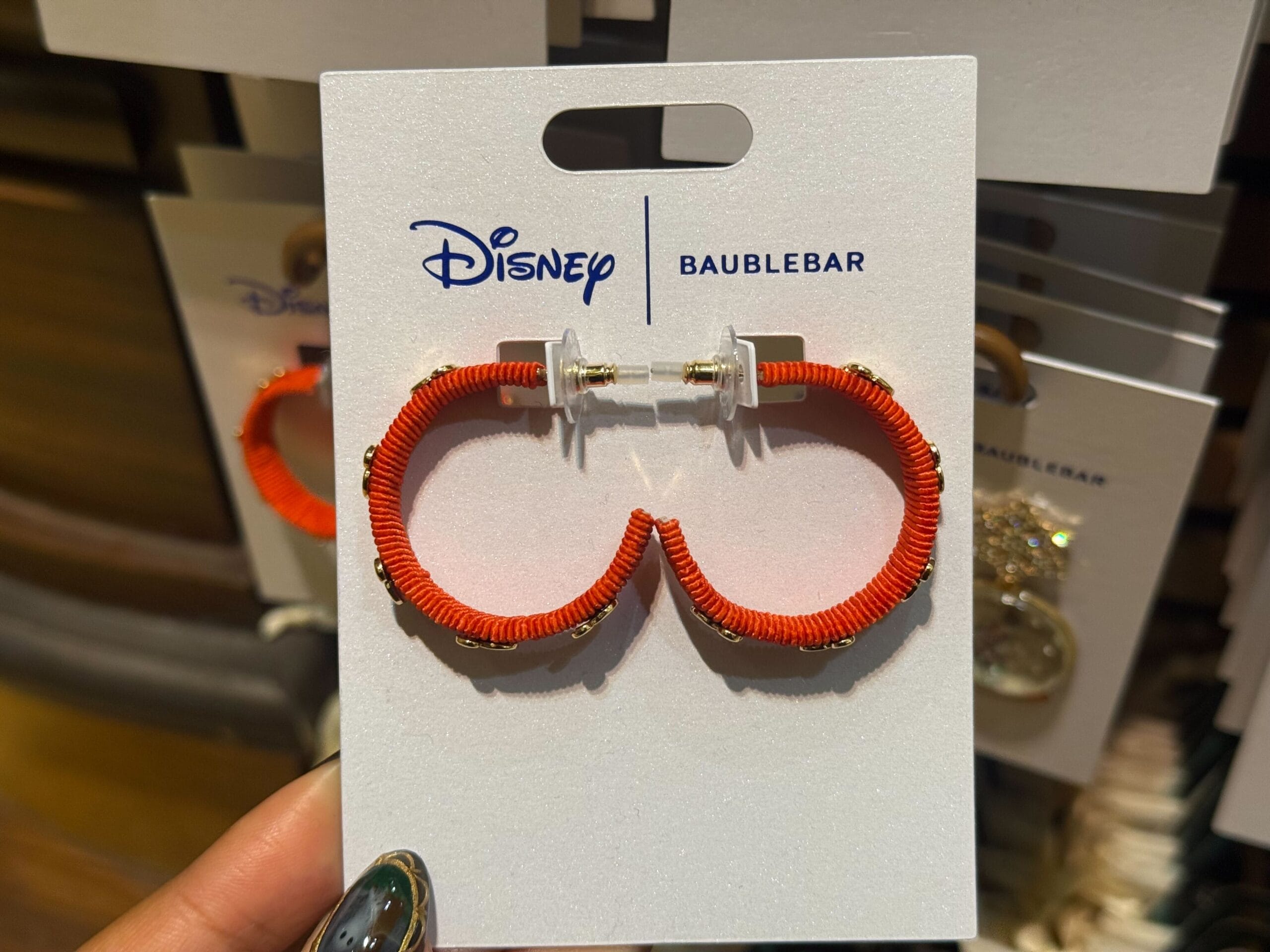 Close-up of red Mickey Mouse ear earrings from 2025 Disneyland Christmas collection on a BaubleBar card, park merchandise exclusive.
