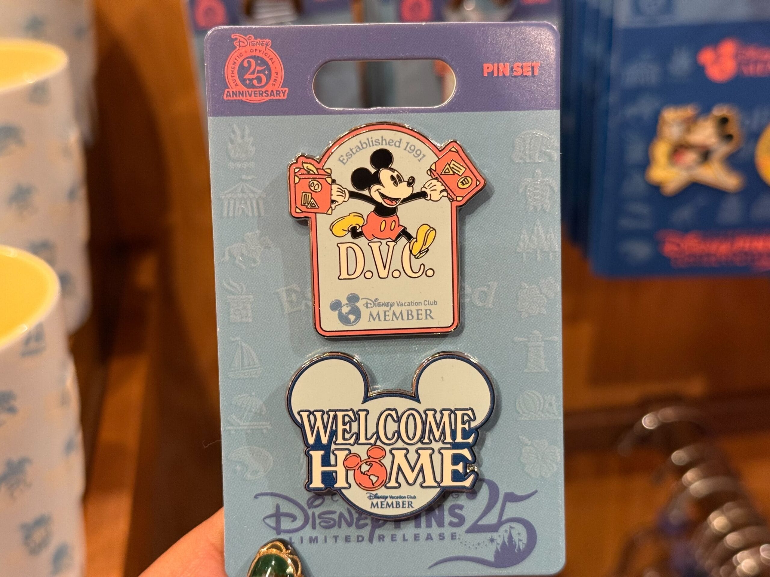 A hand displays exclusive Mickey pins, ideal for Disneyland or DVC collectors; no castle like in Disney Parks is visible.
