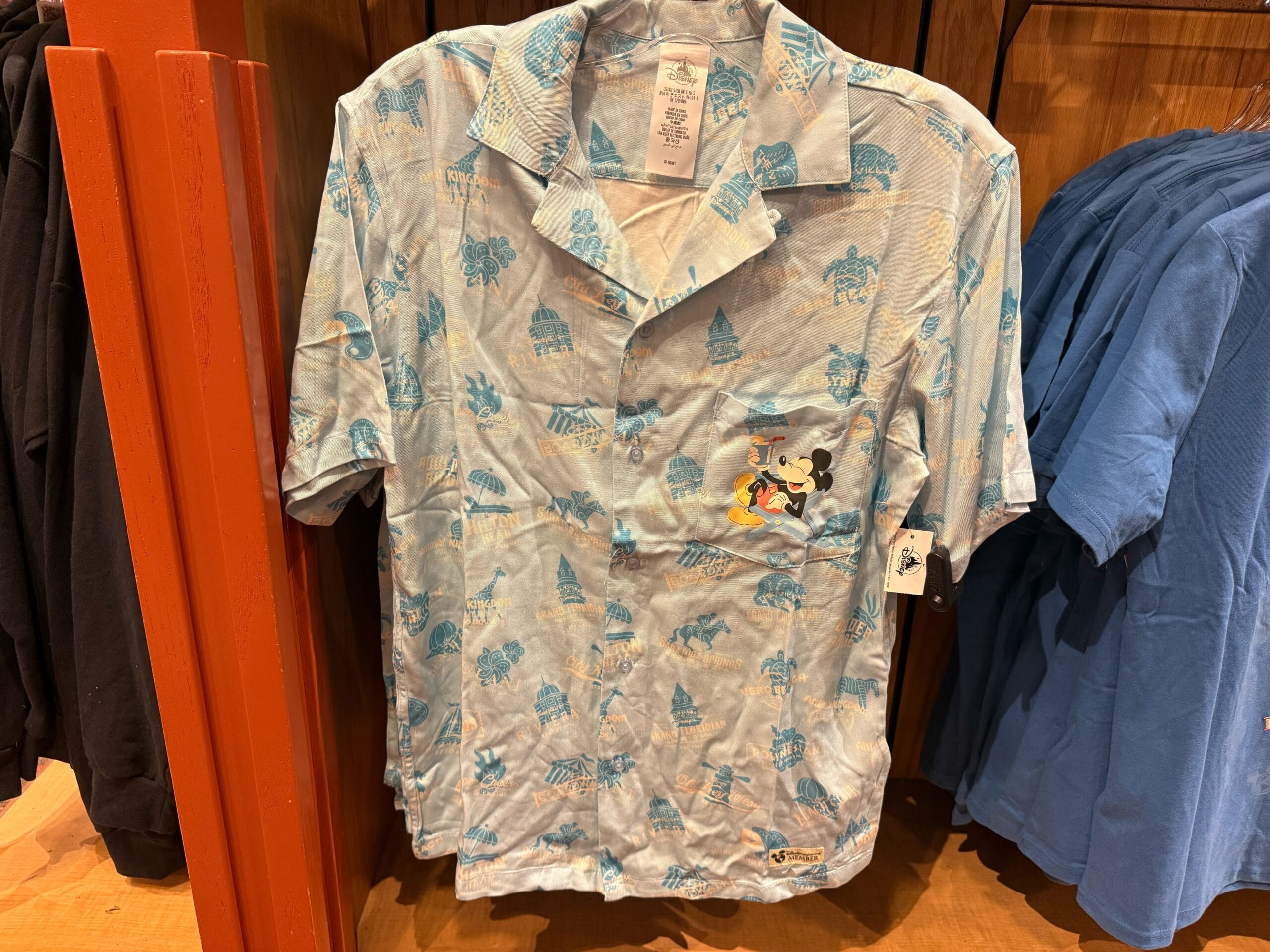 Light blue shirt with blue prints and a Mickey Mouse graphic, a stylish choice for Disneyland parkgoers and Mickey fans.