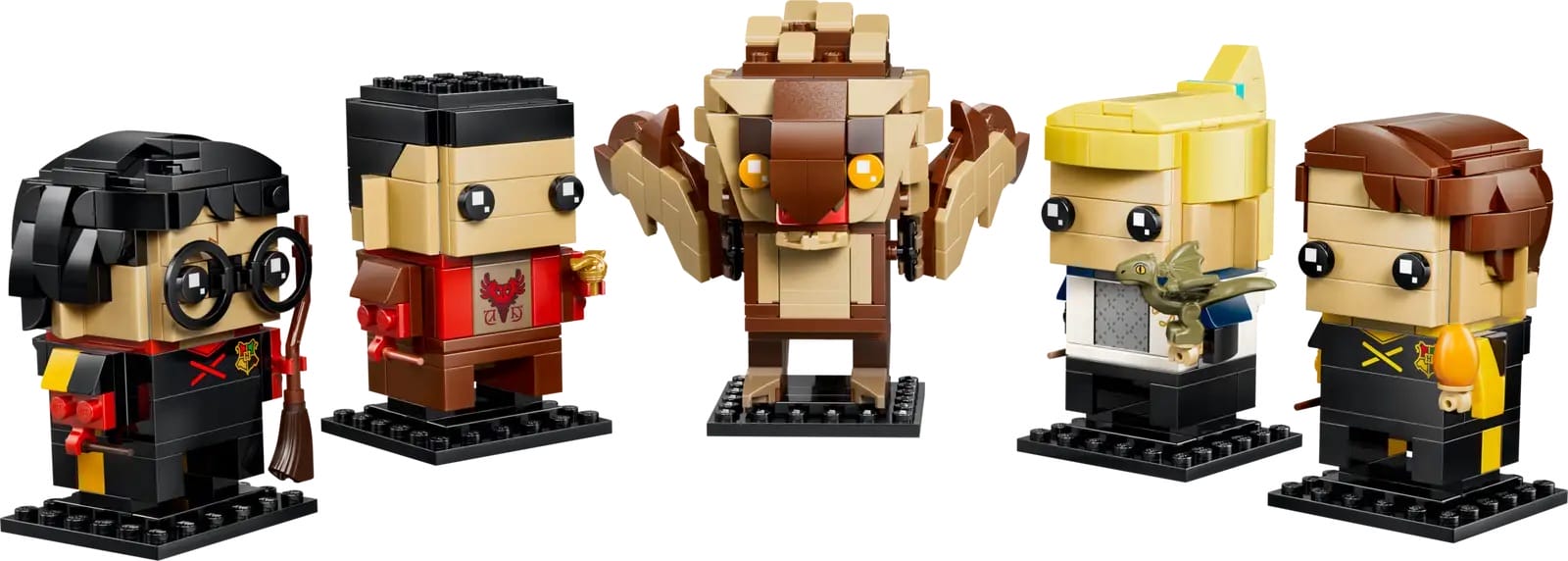 Five LEGO-style block figures from Universal movies stand in a row on black bases, unlike Disney castle figures or park icons.
