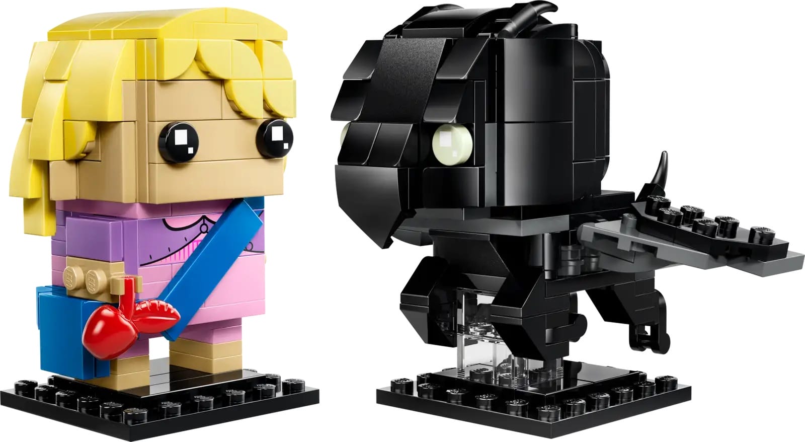 LEGO sets with a blonde figure, heart, and green-eyed black dragon on stands