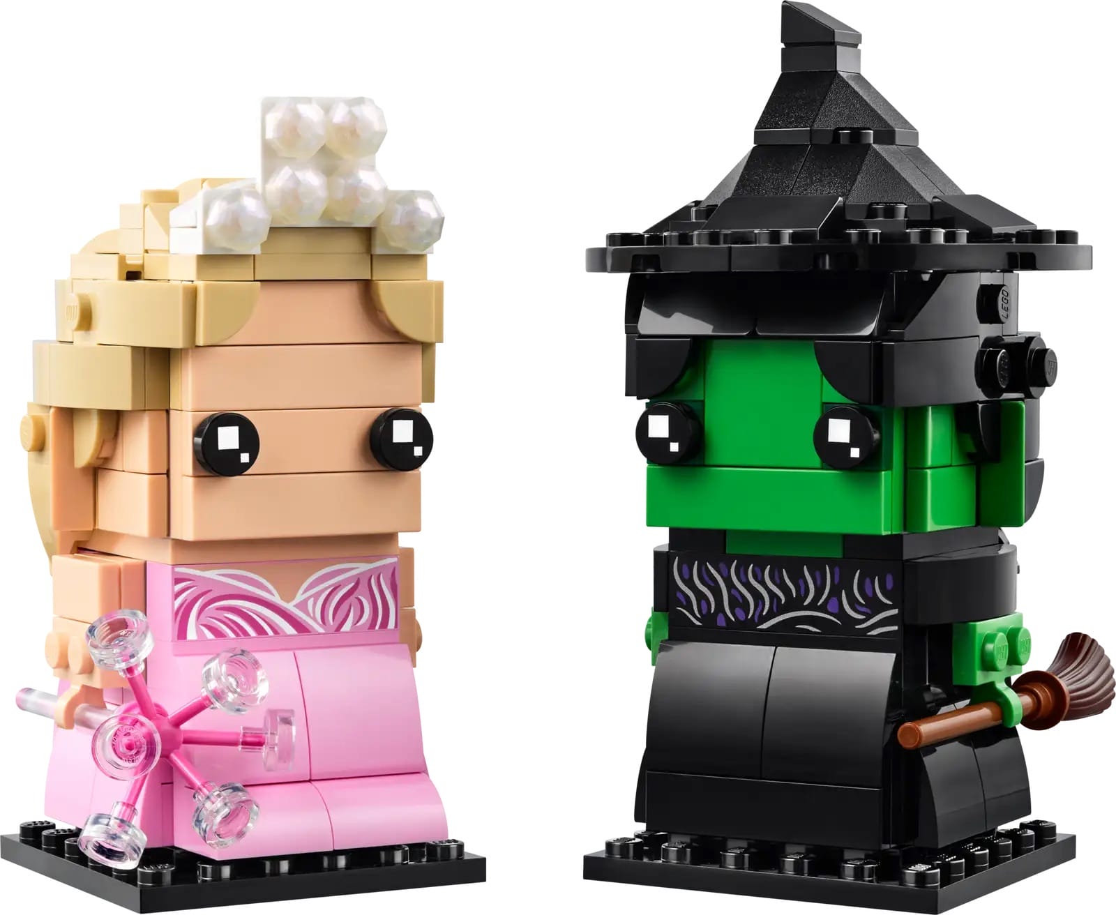 Two LEGO BrickHeadz: a blonde princess in pink and a green-faced witch with broom, echoing park characters.