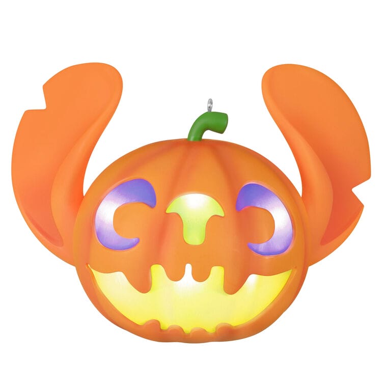 Orange pumpkin jack-o’-lantern with Mickey ears, glowing face, and green stem—reminiscent of Main Street’s park decorations.