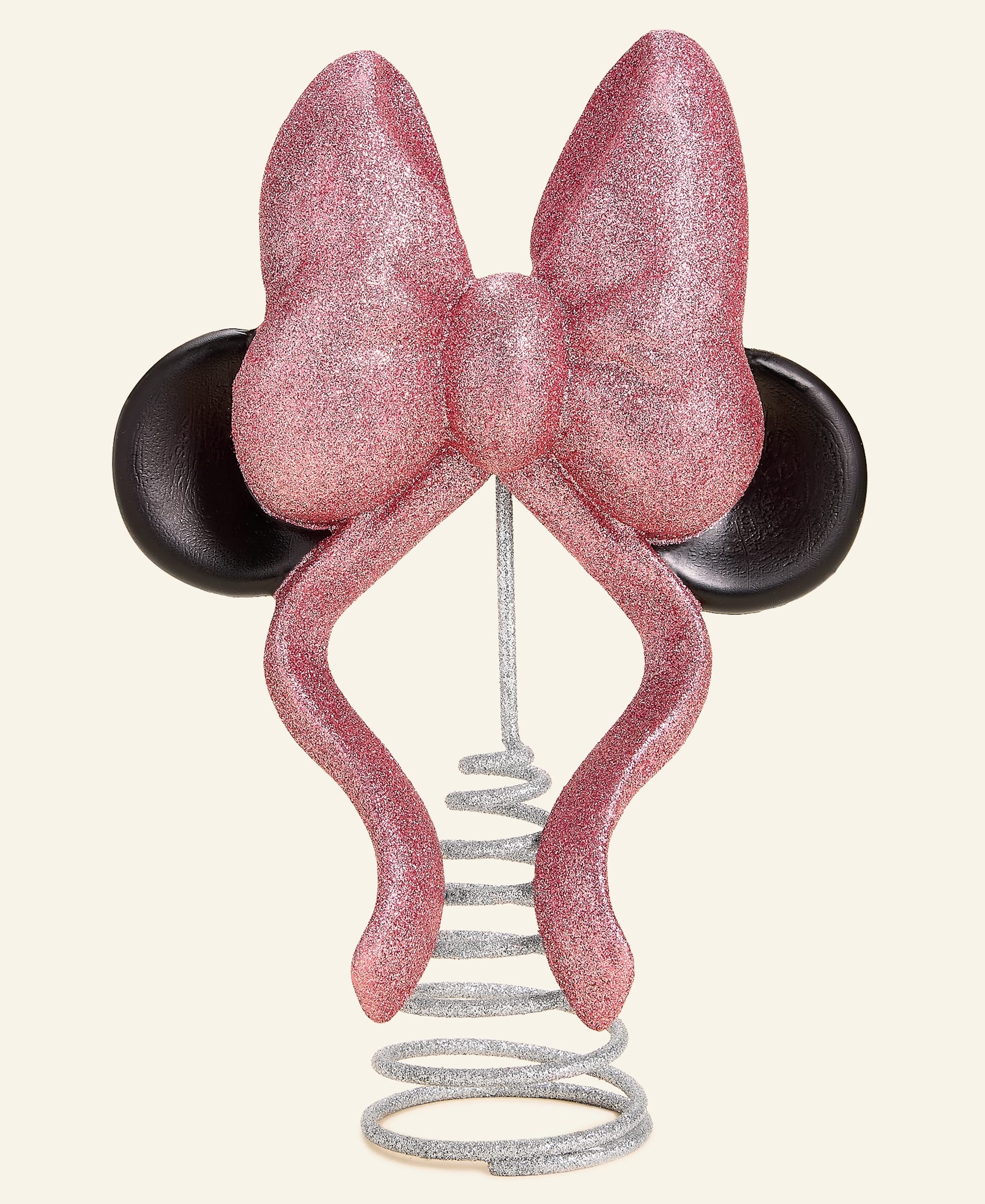 A glittery pink bow with black mouse ears and a silver spring base, inspired by Disney parks' festive style, from Macy's collection.