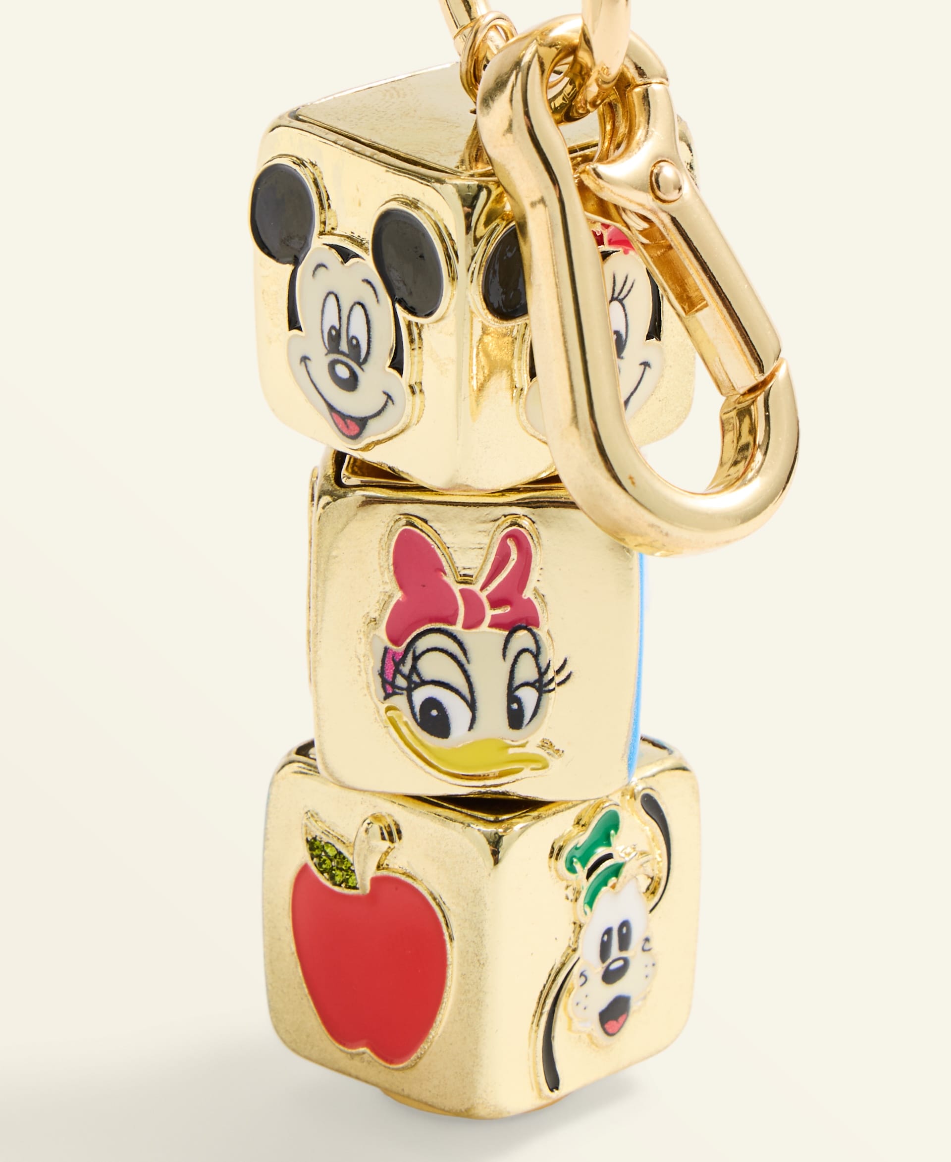 Gold keychain featuring Disney cube charms—a mouse, duck, and dog—plus an apple, reminiscent of Disney Park souvenirs.