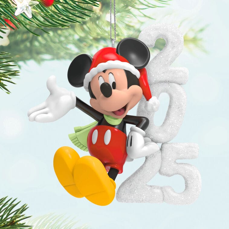 Mickey Mouse in a Santa hat hangs on a tree, like ornaments found near Main Street, with Disney Parks holiday magic for 2025.