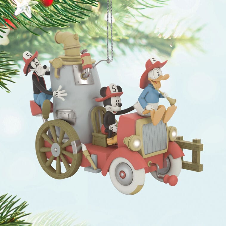 Mickey, Donald, and Goofy ride a vintage fire truck in a Disney Parks-inspired Hallmark ornament, perfect for your tree.