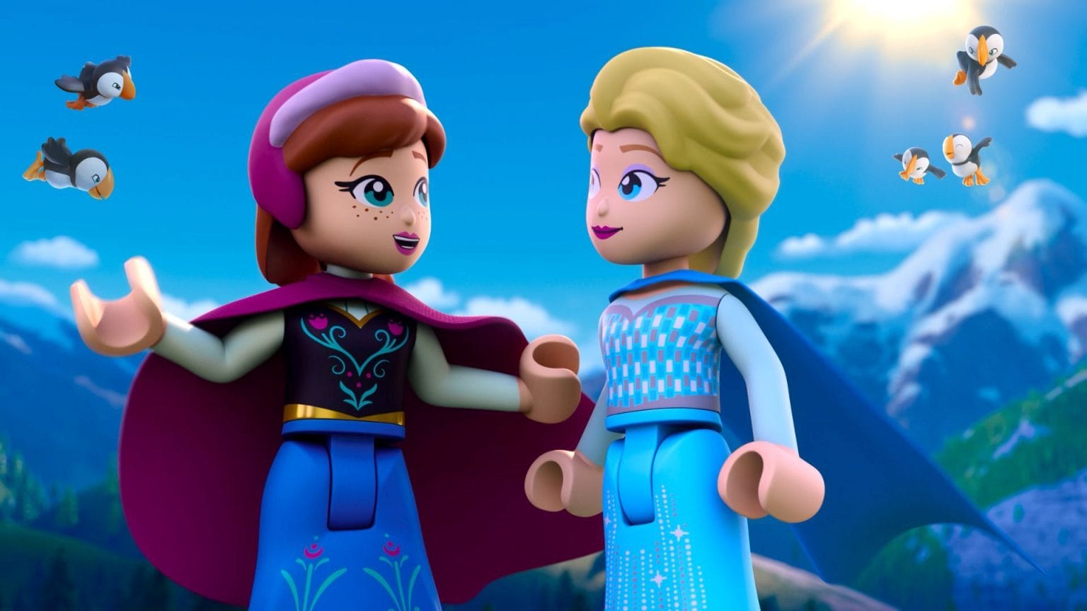Two LEGO figures as Anna and Elsa smile outdoors with mountains, sun, and birds—no Disney castle like those in the parks visible.