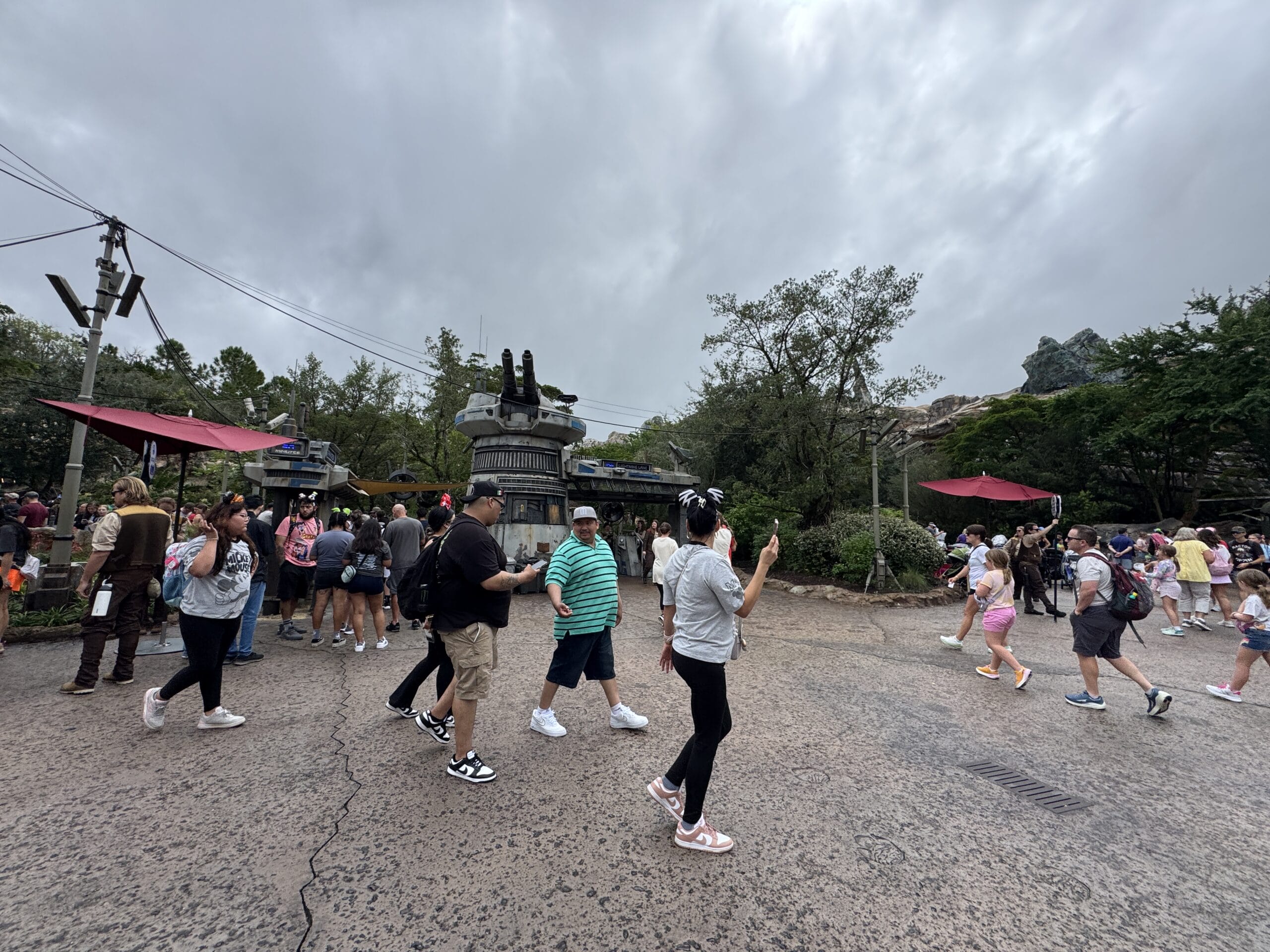 Guests walk through a Star Wars-themed land at Tokyo Disney Resort on a cloudy Halloween, with no castle in sight to compare.