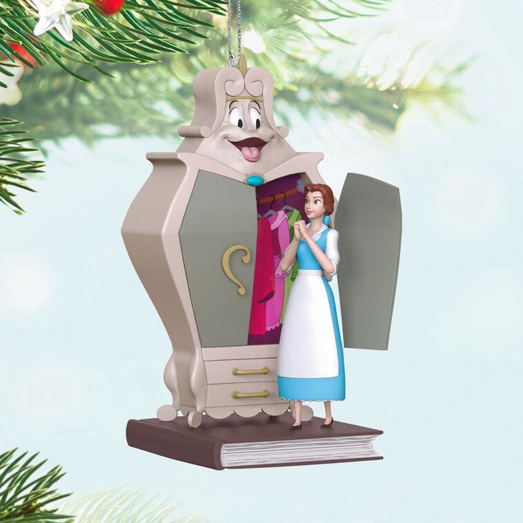 Animated Hallmark Keepsake Ornament of Belle beside her wardrobe, hangs on a tree, evoking Fantasyland’s fairy-tale Disney charm.