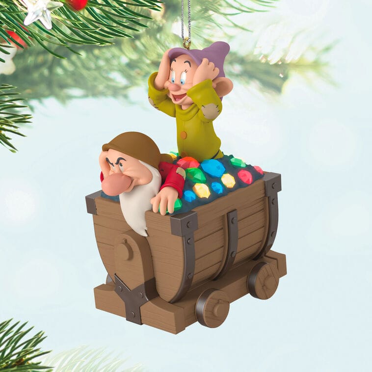 Dopey and Grumpy ride a gem-filled mine cart Hallmark Disney Keepsake Ornament on a tree, reminiscent of park decor at Disney resorts.