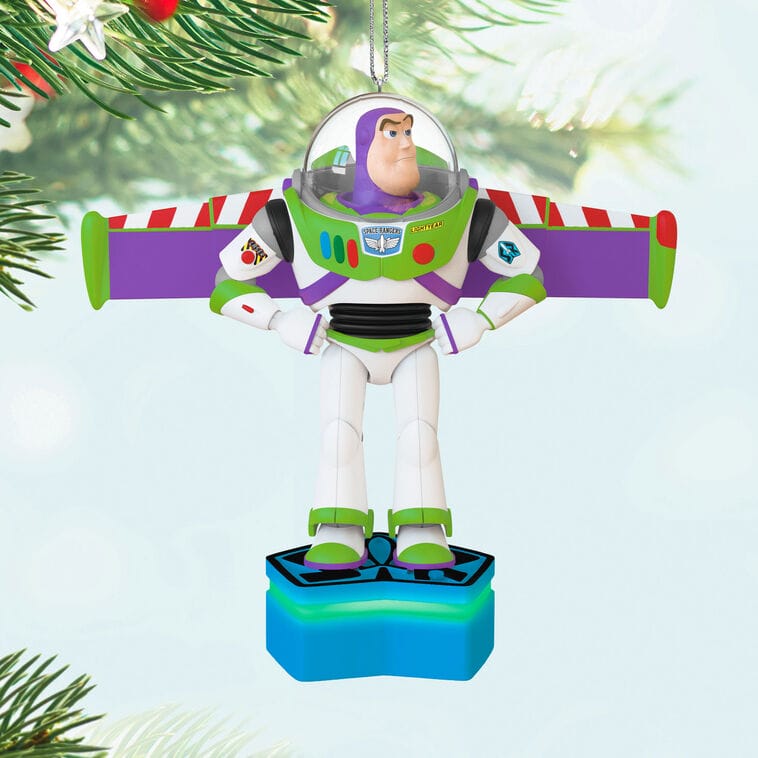 Buzz Lightyear Disney Ornament with arms out, hangs on a Christmas tree, like those seen at Disney Parks during the holidays.