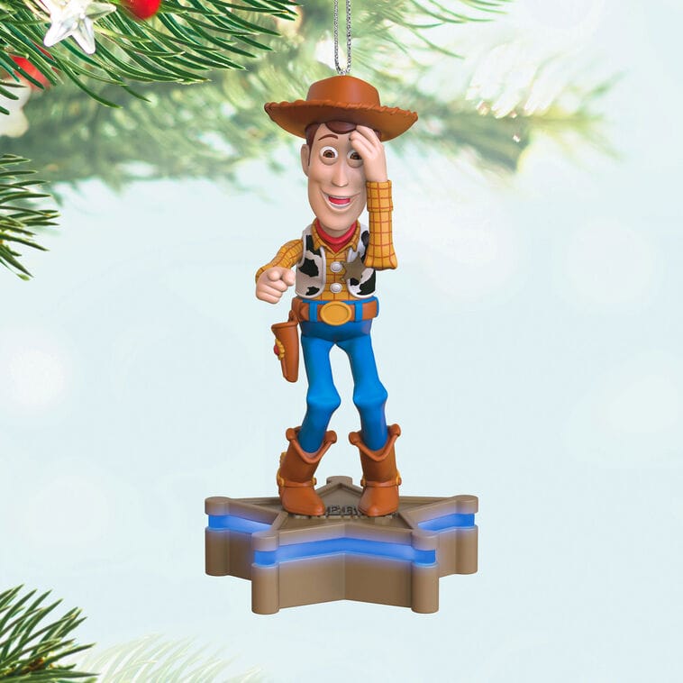 Woody Disney Keepsake Ornament from Hallmark hangs on the tree, standing on a star base and tipping his hat, like in the parks.