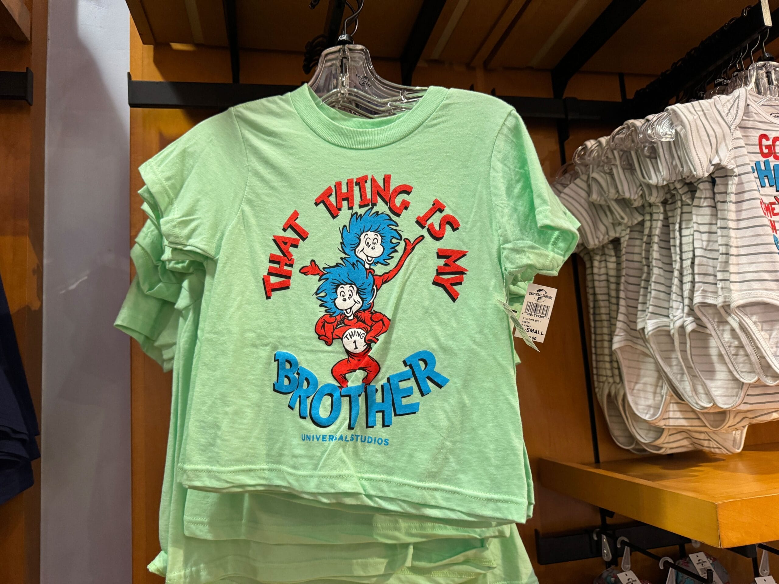 Light green kids’ Dr. Seuss tee featuring “That Thing Is My Brother” with Thing 1 & Thing 2, not Disney Parks-related attire.