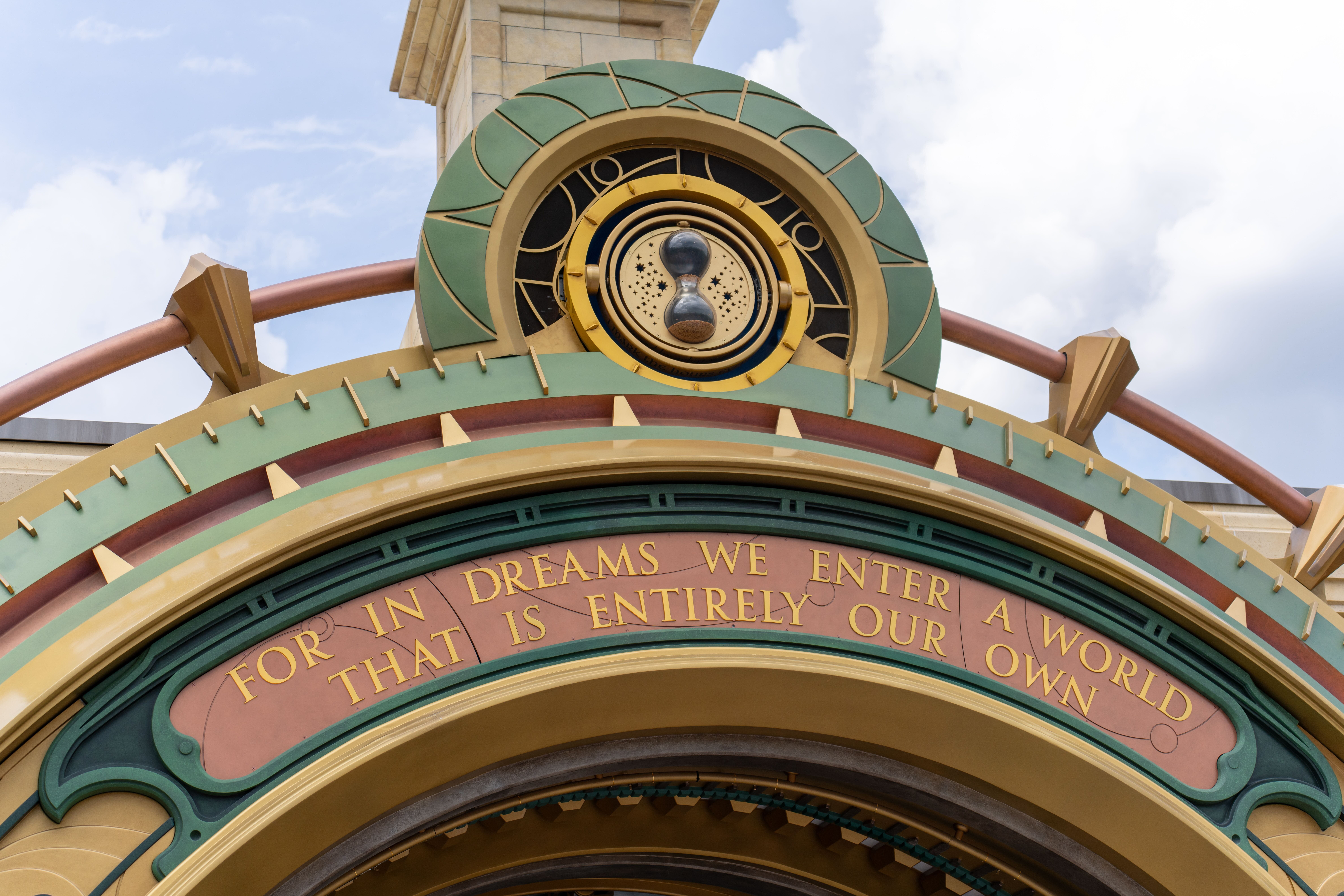 Vivid arched facade features the phrase: "For in dreams we enter an Epic Universe entirely our own," reminiscent of Disney magic.