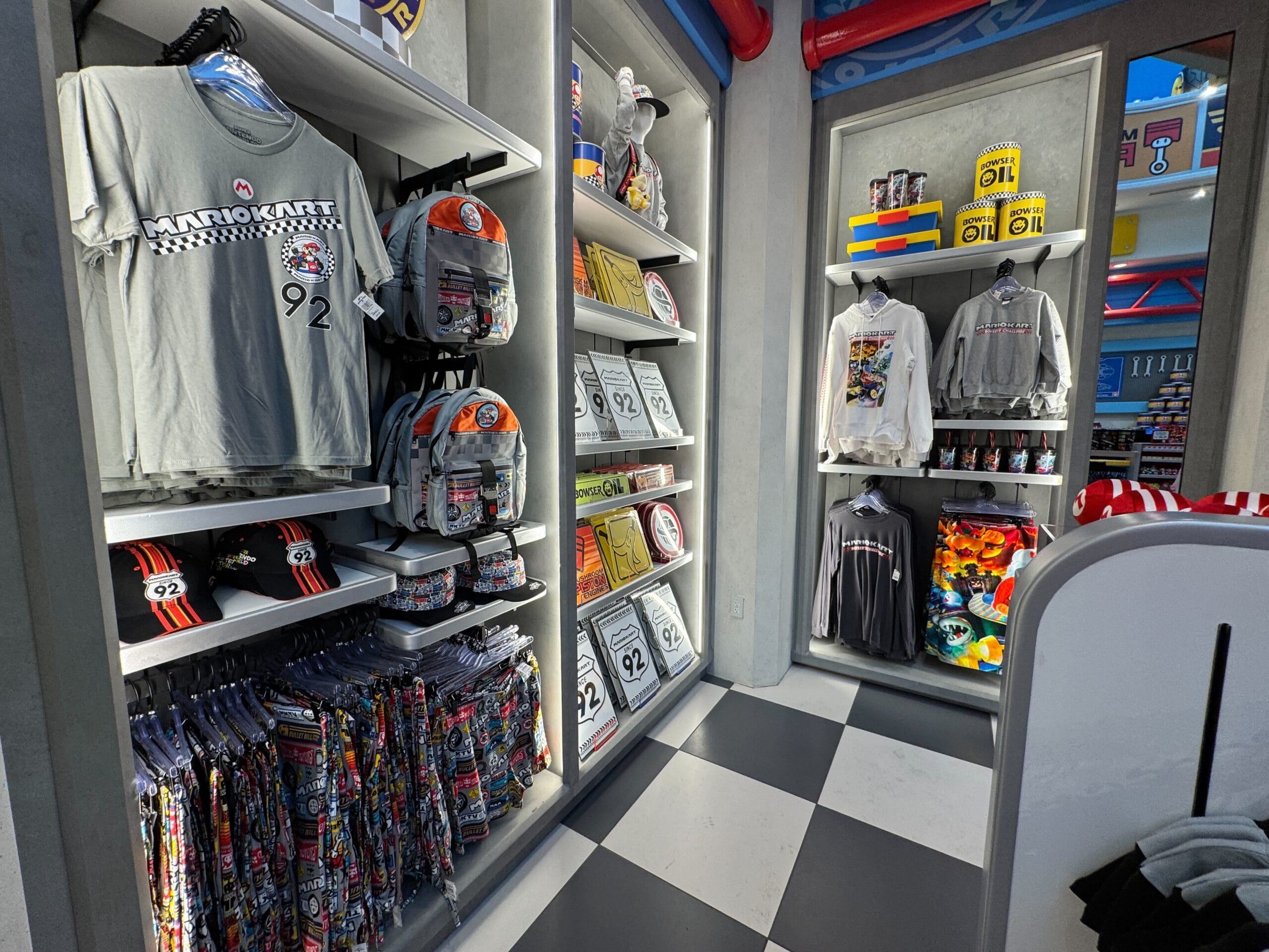 Mario and Nintendo gear fill shelves in a checkered-floor shop, echoing Disney's themed stores but without a classic castle.