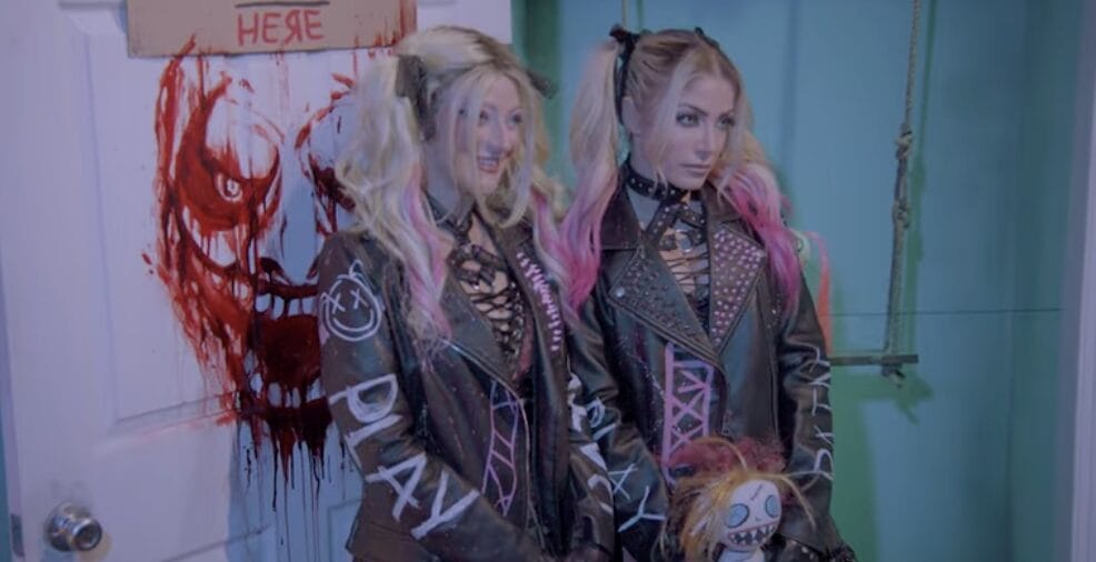 Two women, one like Alexa Bliss, pose by a blood-splattered door at Halloween Horror Nights in Universal Orlando—not at Disney.