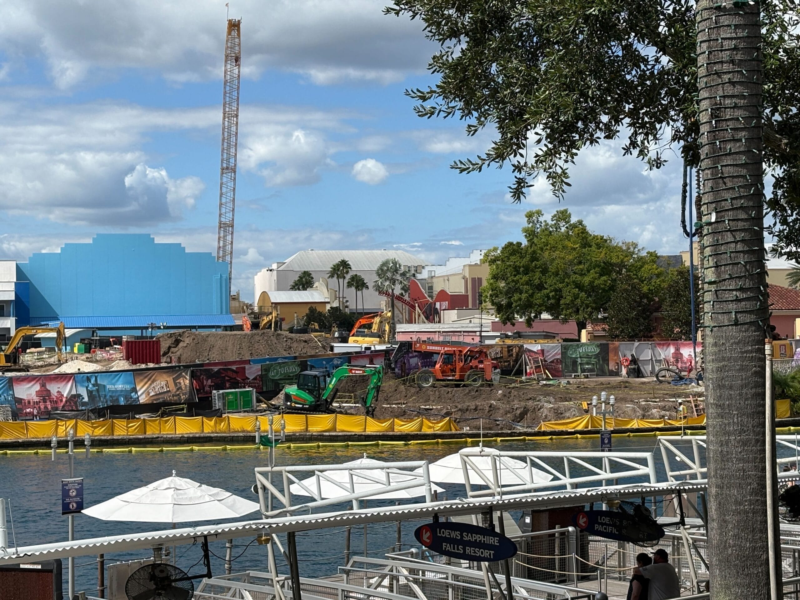 Construction site with a crane and machinery by a waterfront at Universal Studios Florida.
