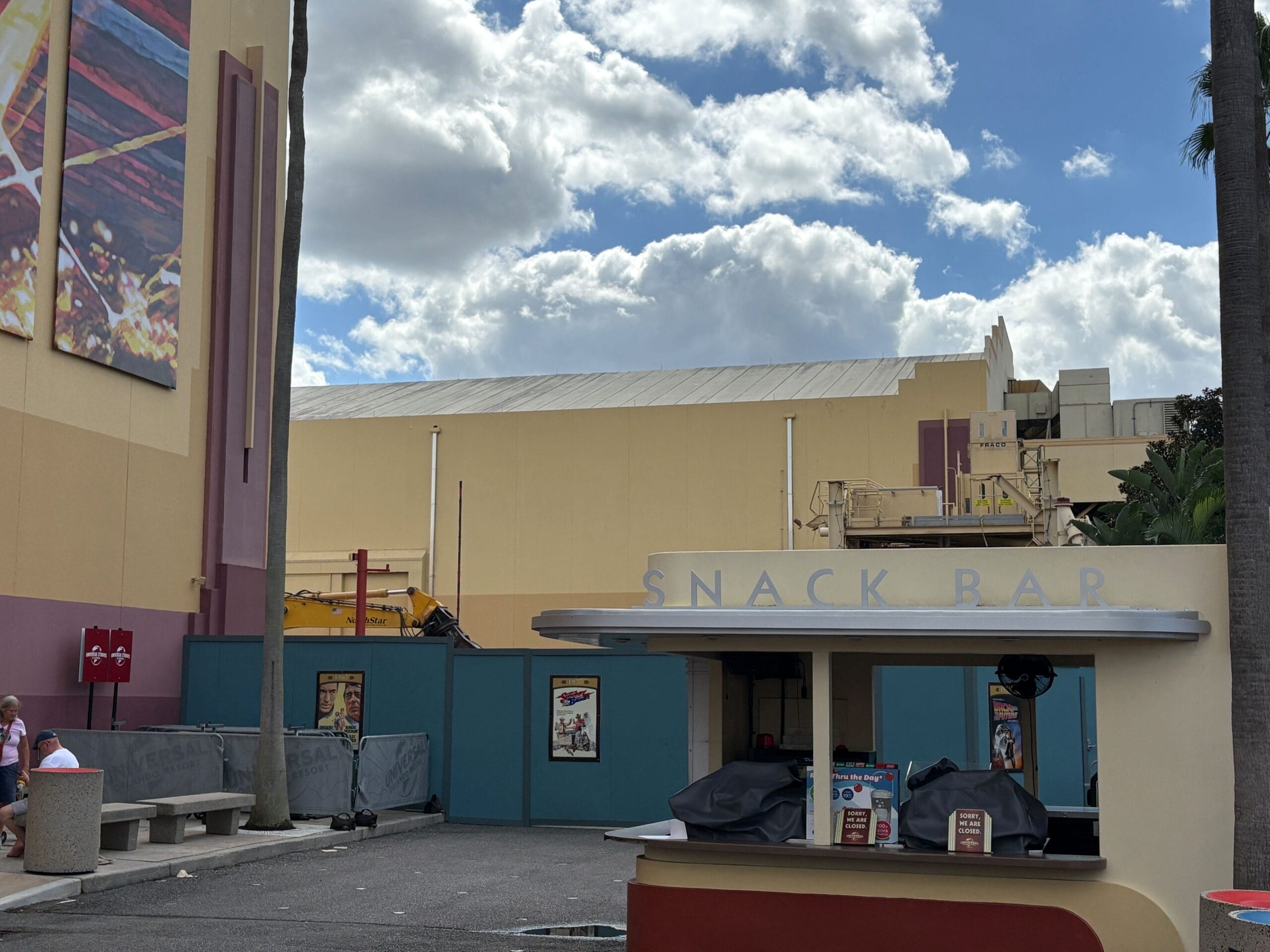 Small closed snack bar by construction walls near Rip Ride Rockit at Universal Studios Florida, no castle like those in Disney parks.