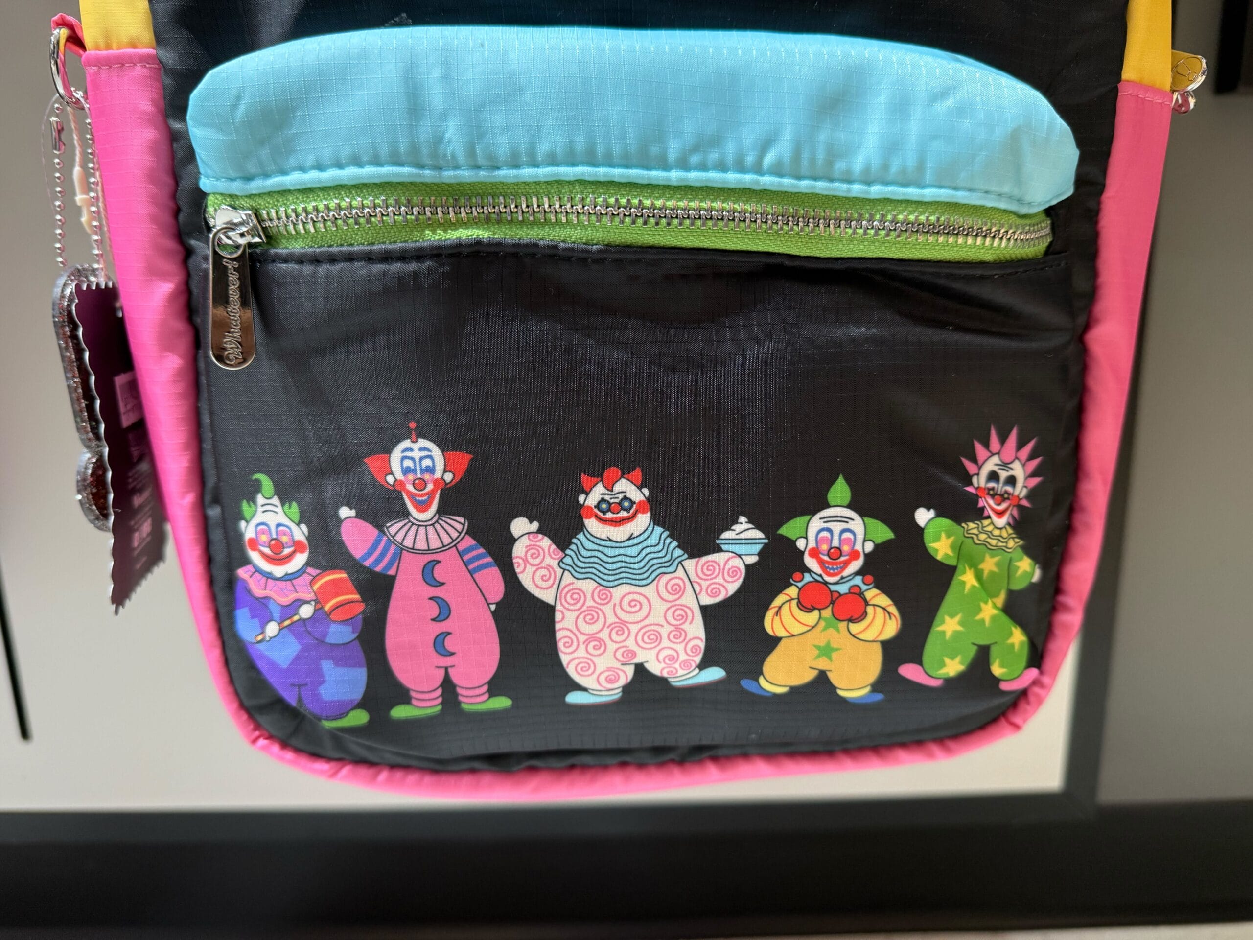 A vibrant bag pocket with five playful cartoon clowns in costume from Killer Klowns from Outer Space.