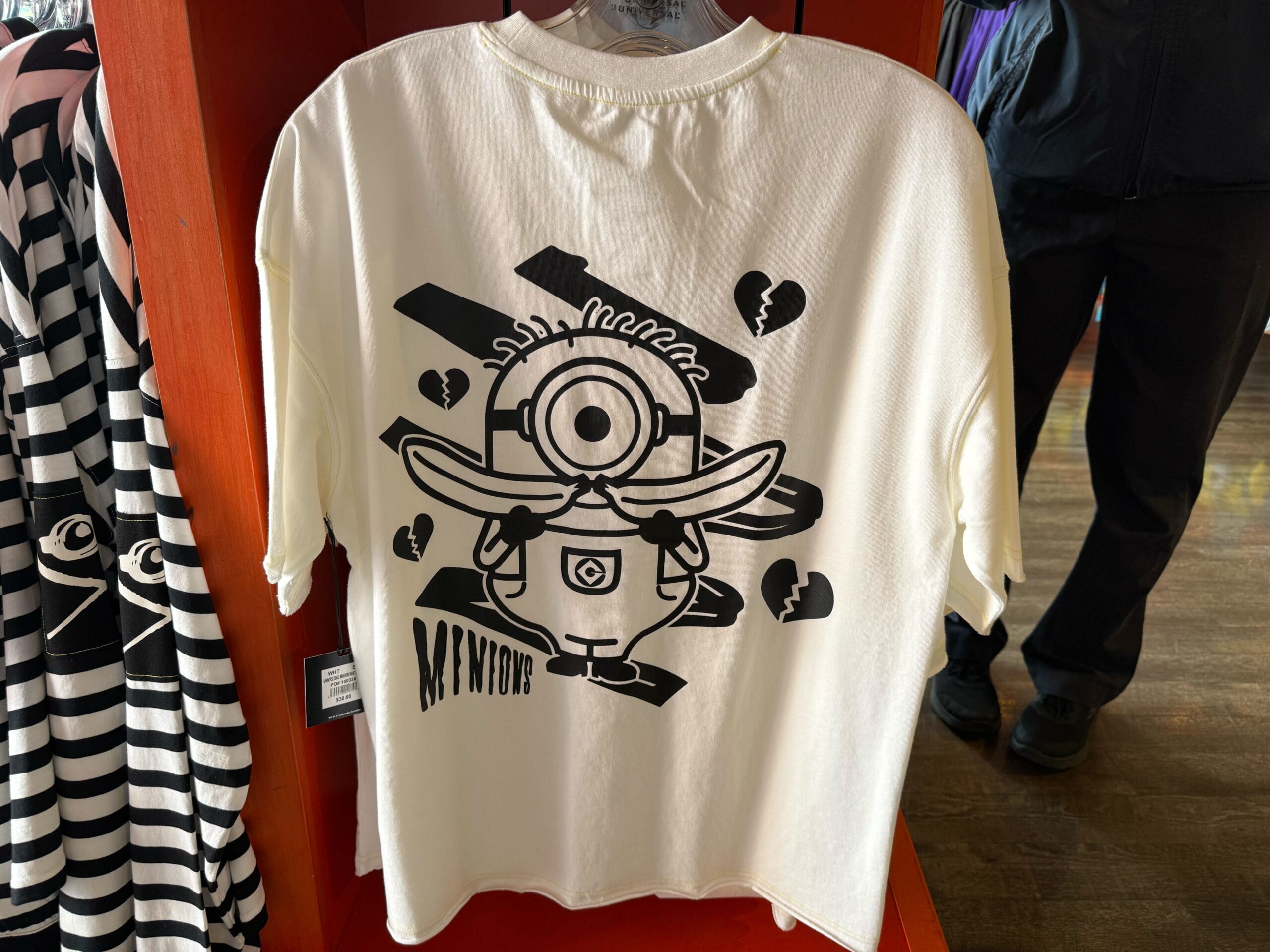 White tee with an Emo Minion and broken hearts—Universal Studios Hollywood exclusive, not to be confused with Disney Park merch.