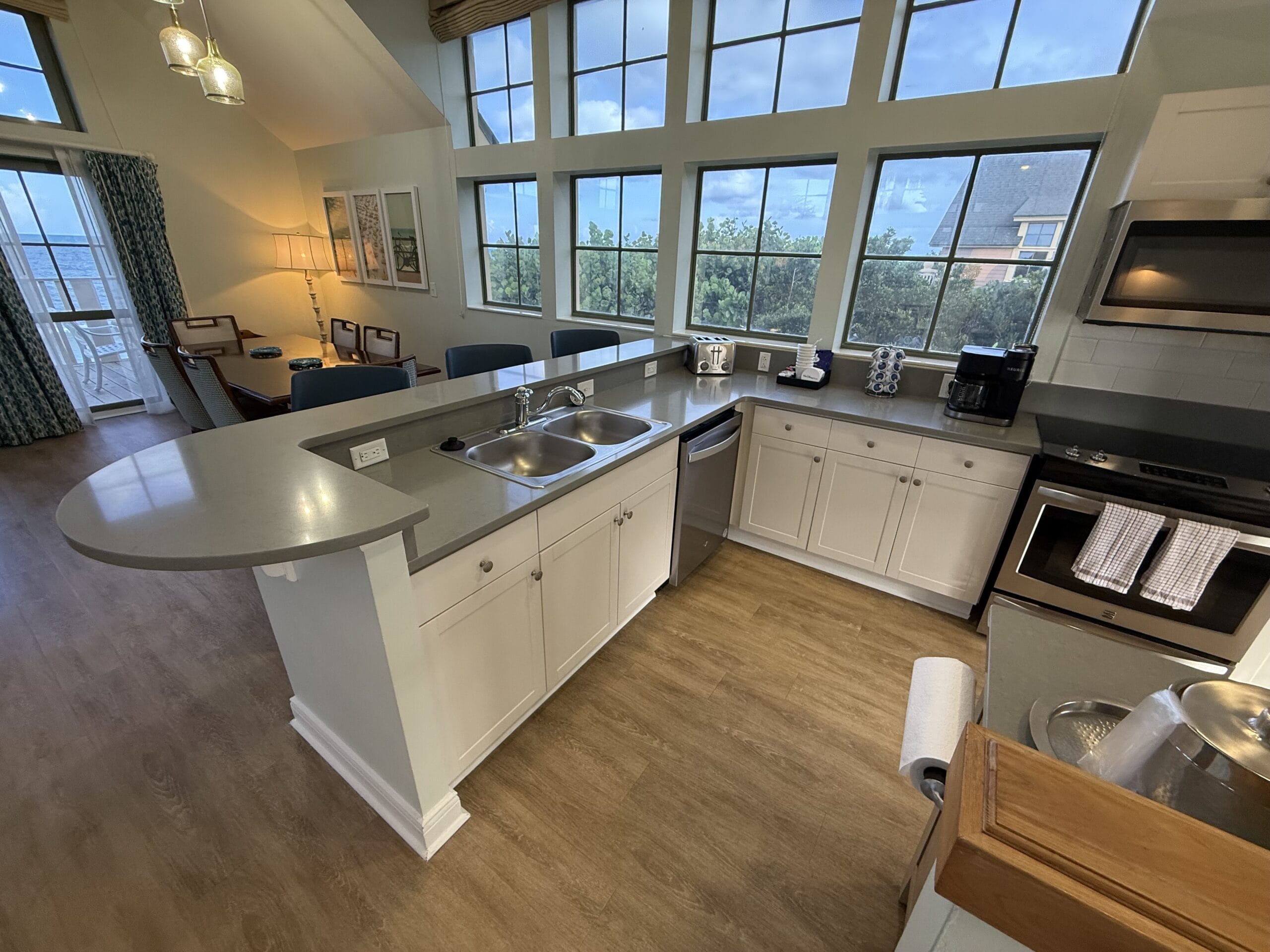 Modern kitchen in 3-bedroom cottage at Disney's Vero Beach Resort, gray counters, white cabinets—no iconic castle views here.