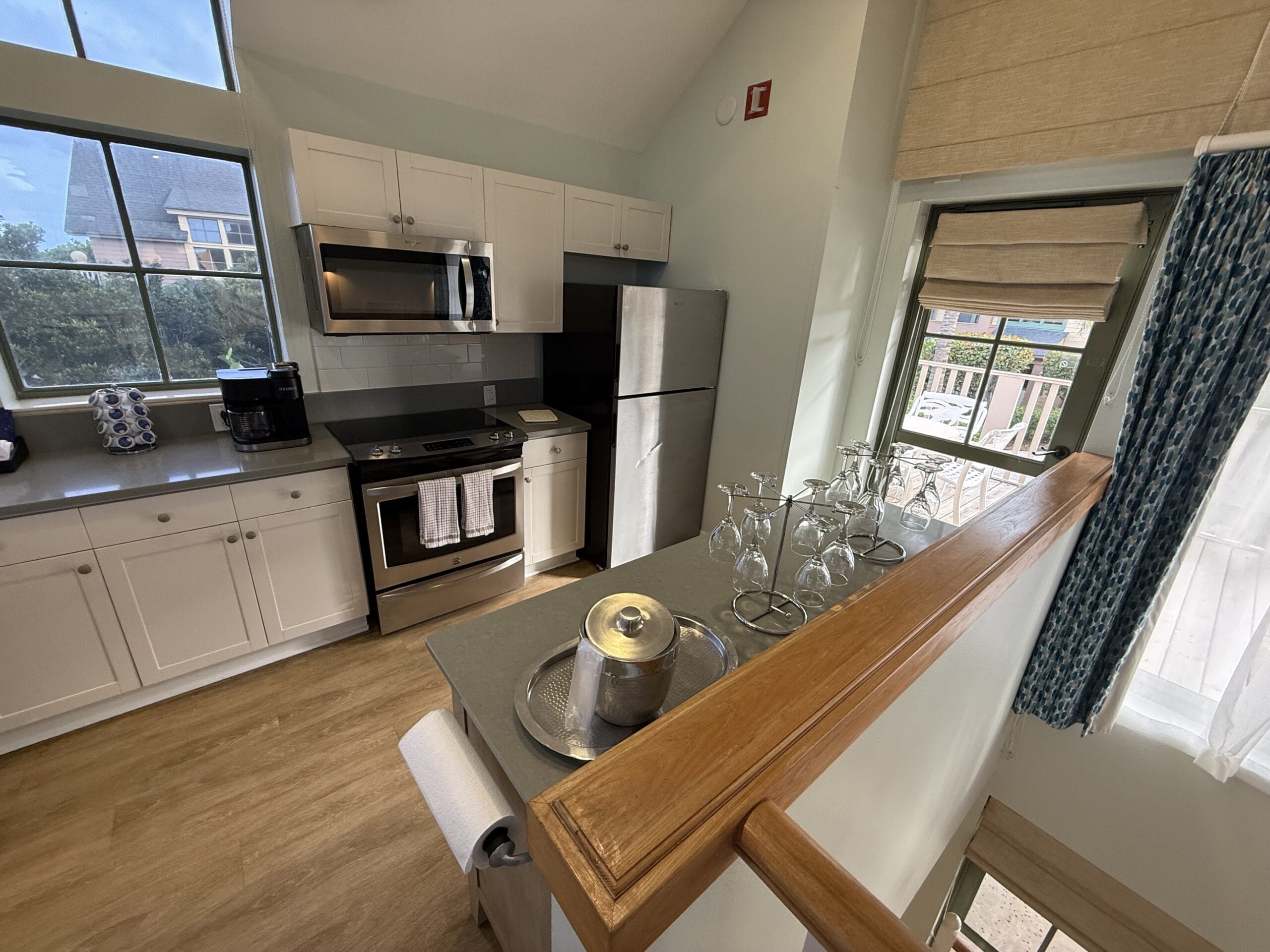 Sleek kitchen at Disney's Vero Beach Resort 3 Bedroom Cottage, featuring stainless appliances and a set counter—no castle in view.