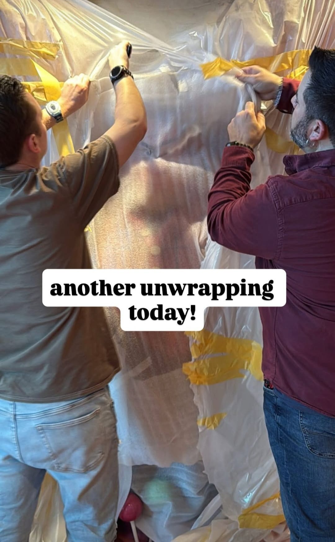 Two men unwrap a large Wreck-It Ralph statue at a Disney park, with "another unwrapping today!" text across the image.