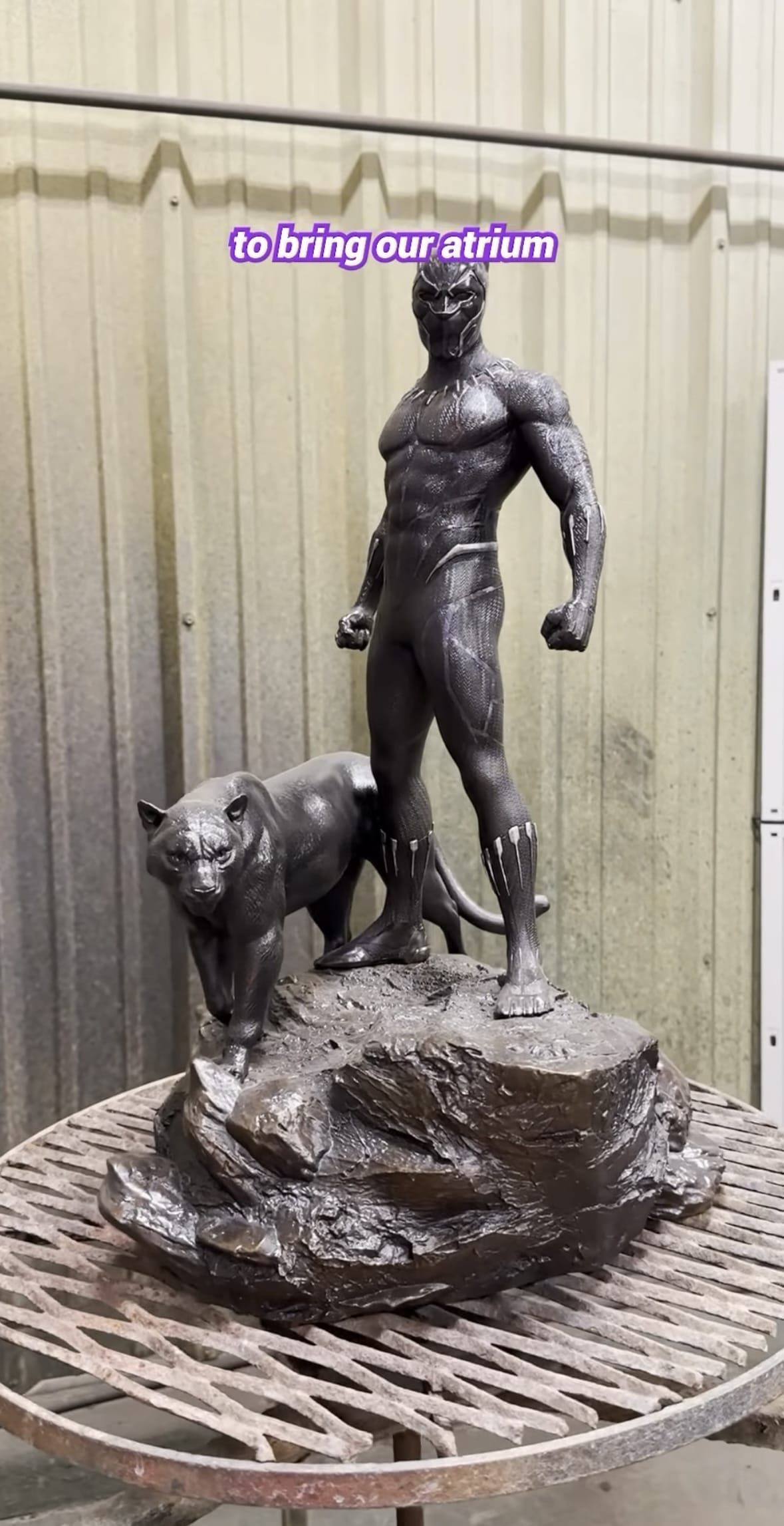A Walt Disney Imagineering statue in the Destiny Atrium features a superhero and panther on a rock, echoing park icon artistry.