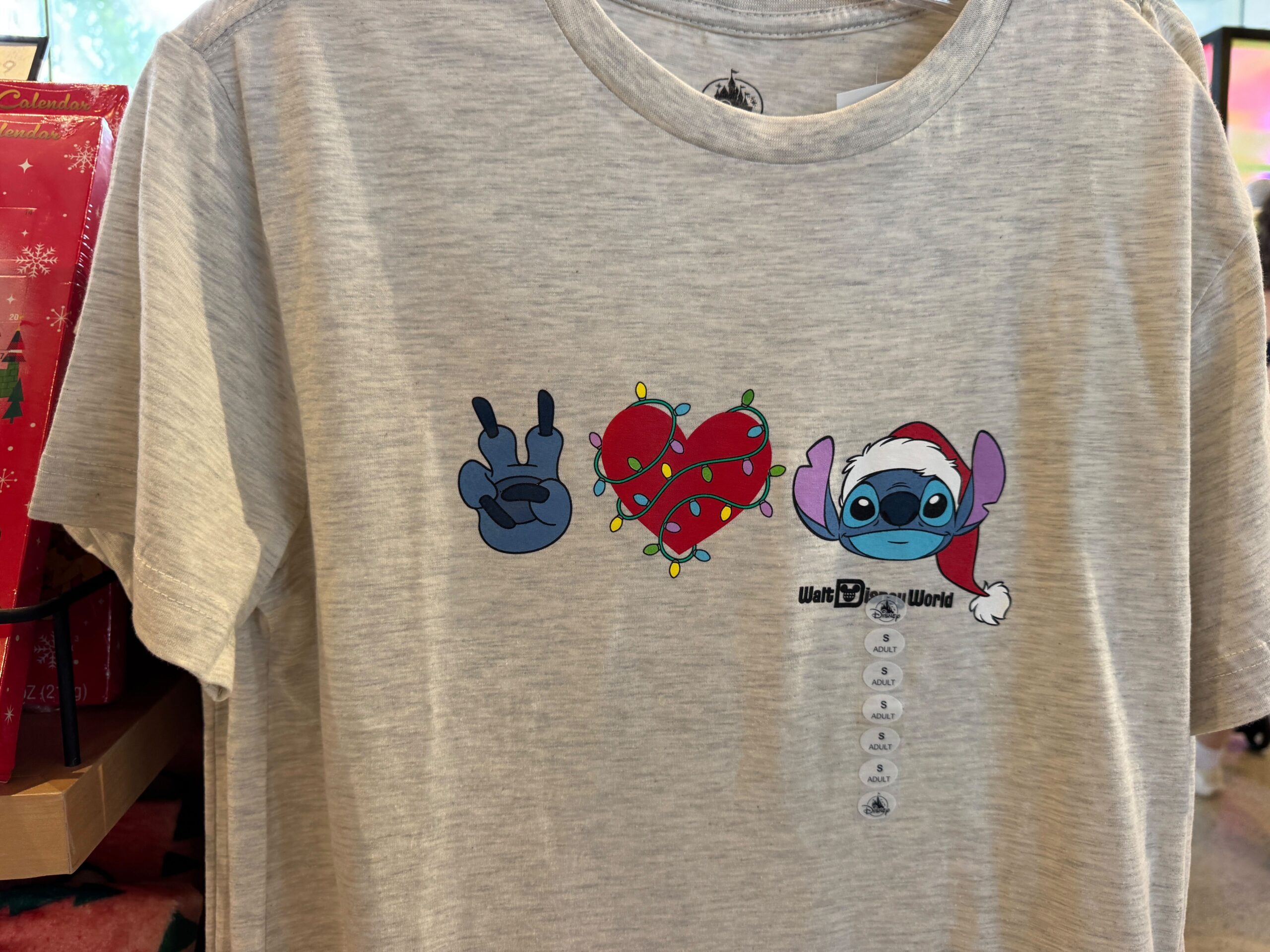 Gray T-shirt featuring Stitch and Christmas lights—festive 2025 Walt Disney World holiday merchandise.