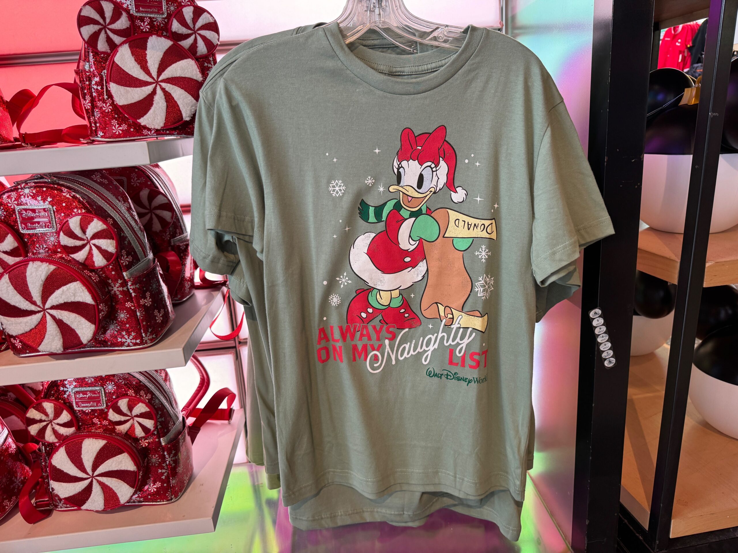 Green t-shirt with Daisy Duck in a Santa outfit, part of Walt Disney World Christmas merchandise for 2025.