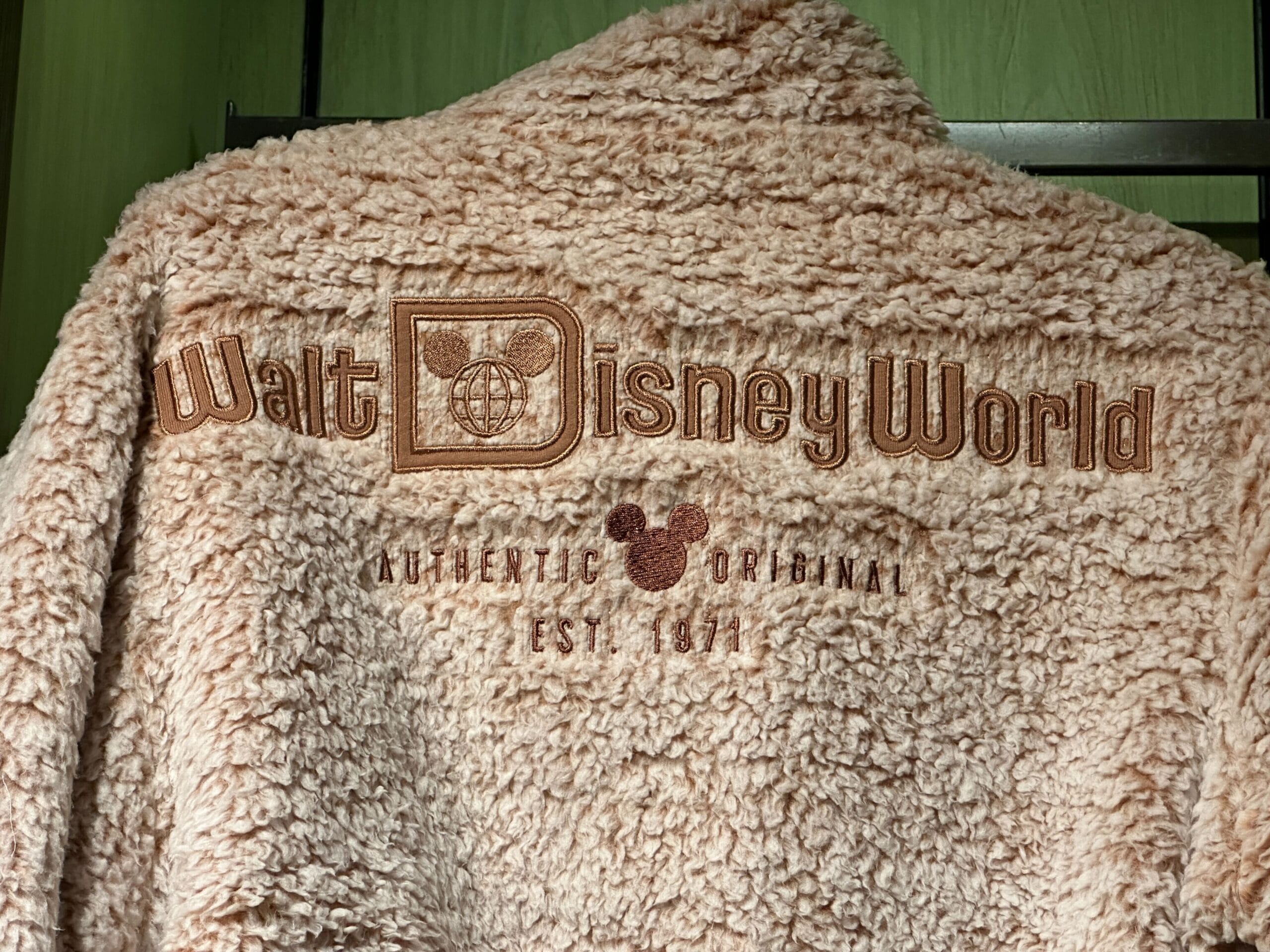 Tan fuzzy “Walt Disney World” jacket with “Authentic Original Est. 1971” on the back, nodding to Magic Kingdom’s opening year.