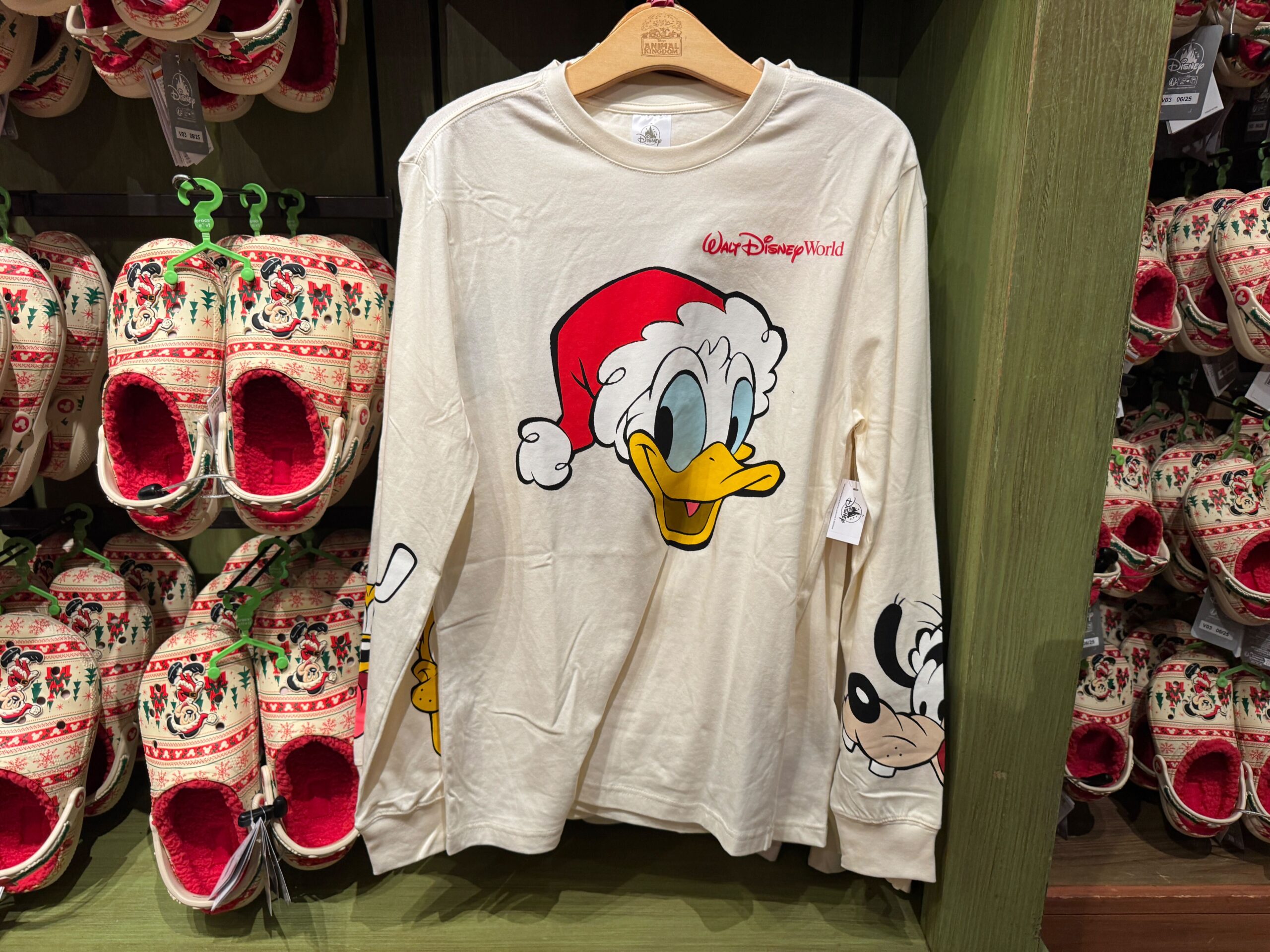 Festive long-sleeve shirt featuring 2025 Christmas merchandise with Santa Donald Duck and “Walt Disney World” text.