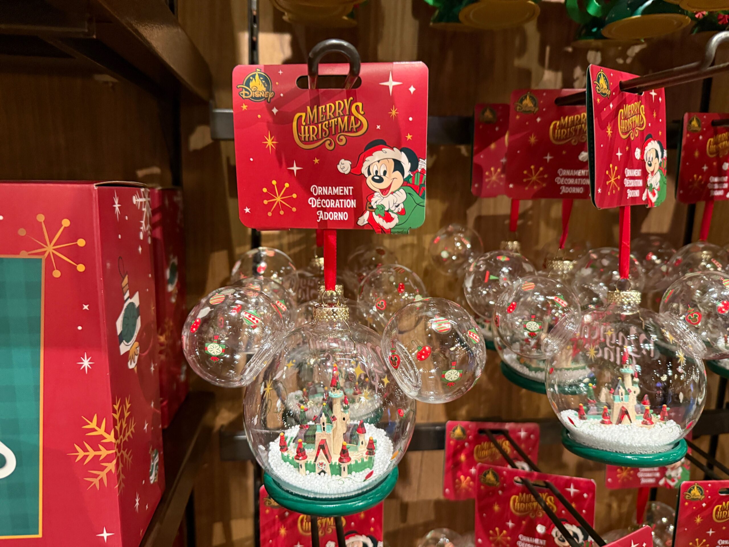 Walt Disney World 2025 Christmas merchandise: Mickey Mouse ornaments with holiday scenes inside clear globes.