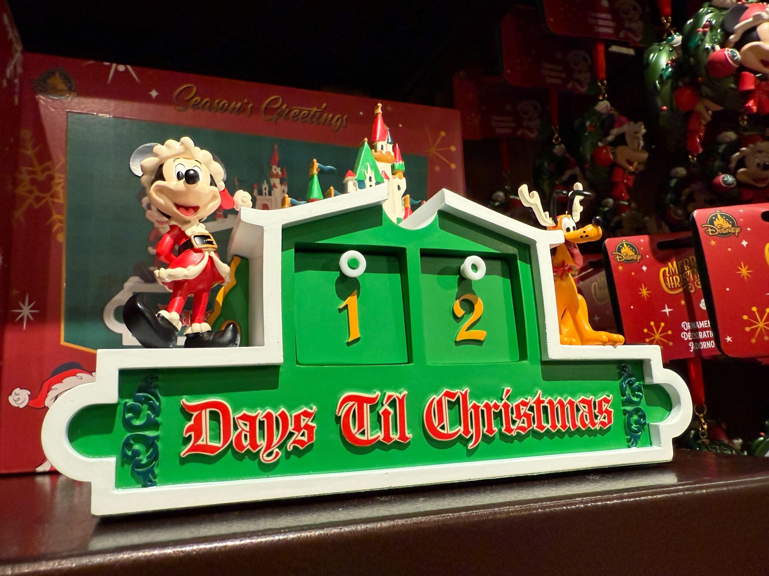 A festive countdown sign reads "12 Days Til Christmas" with a sheep figurine, holiday decor, and Walt Disney World charm.