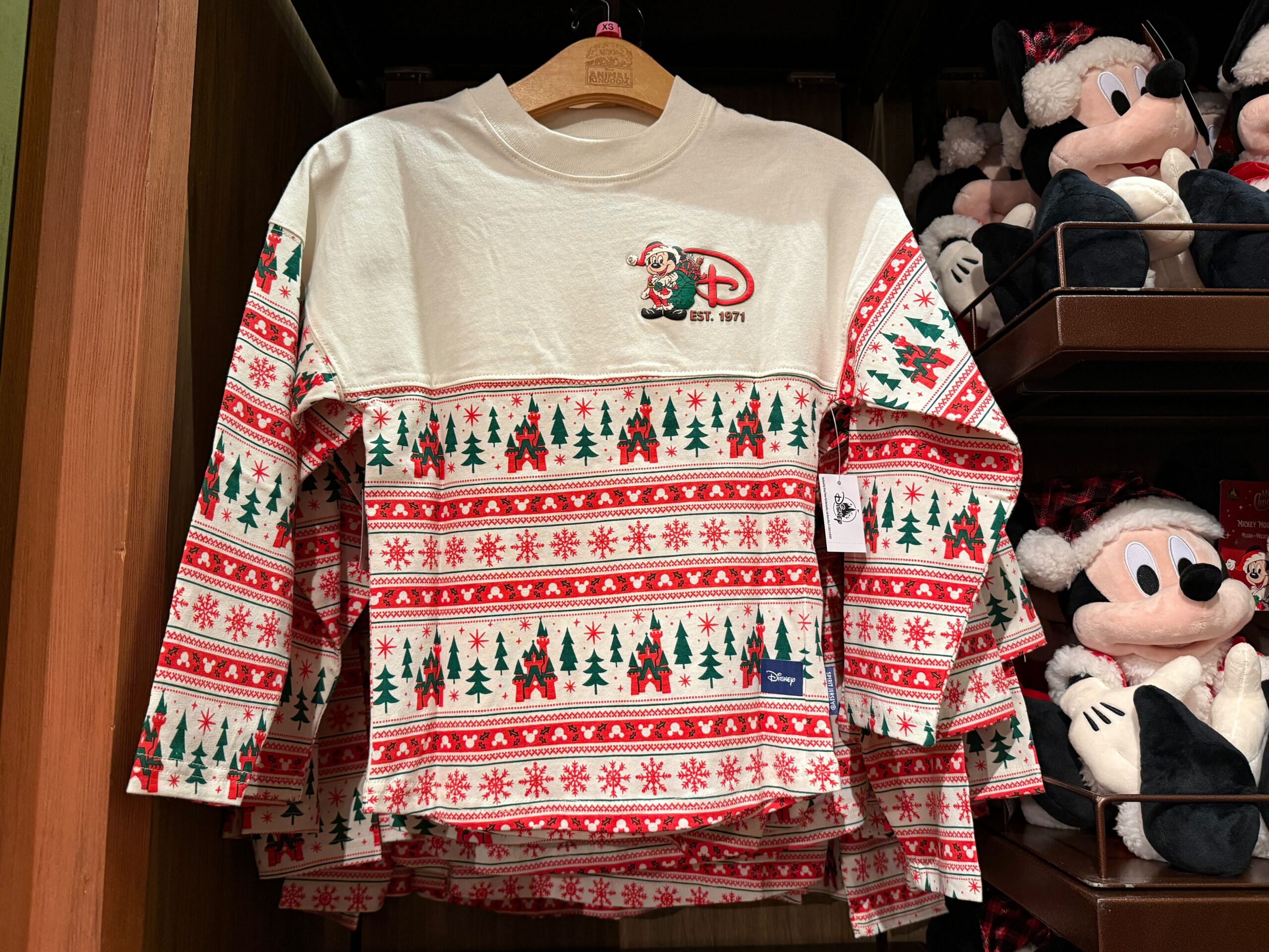 Long-sleeve holiday shirt with red and green patterns, Christmas Mickey Mouse, "D" logo, and 2025 Walt Disney World style.
