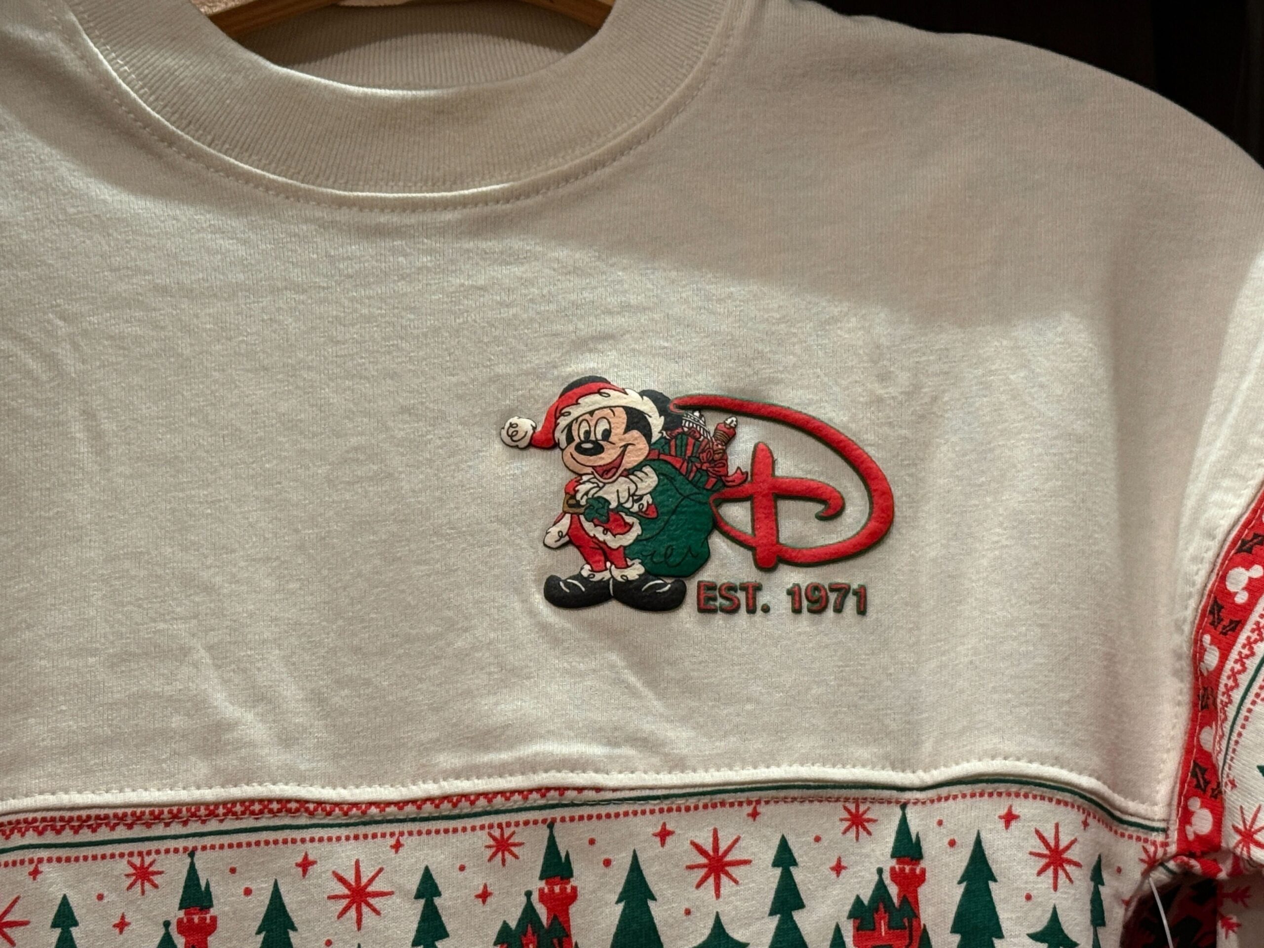 White holiday sweater with Mickey Mouse in a Santa hat, "D," "EST. 1971"—a classic Walt Disney World Christmas merchandise find.