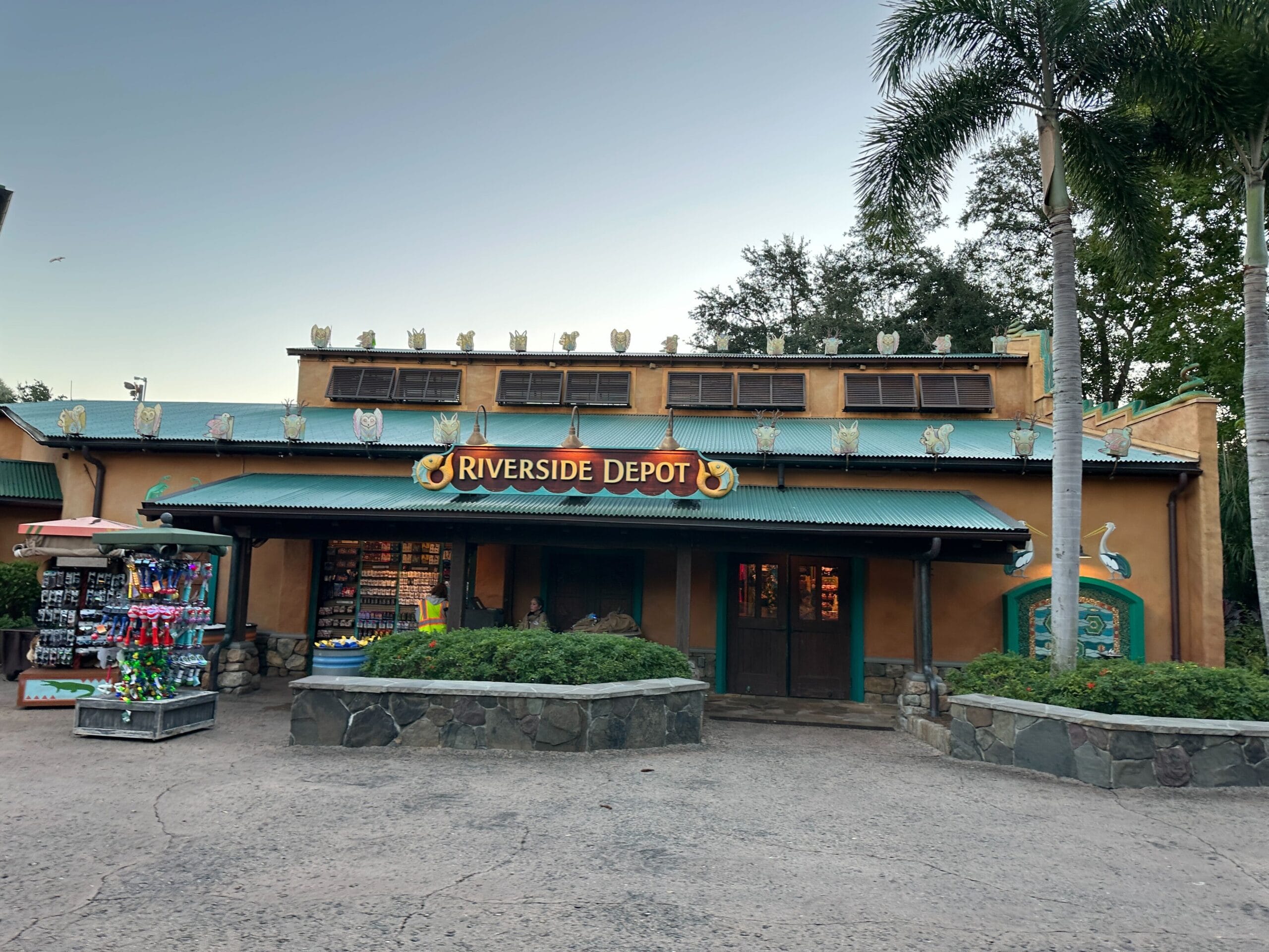 Riverside Depot at Disney's Animal Kingdom features vibrant animal decorations and Christmas decor, but no castle is visible here.