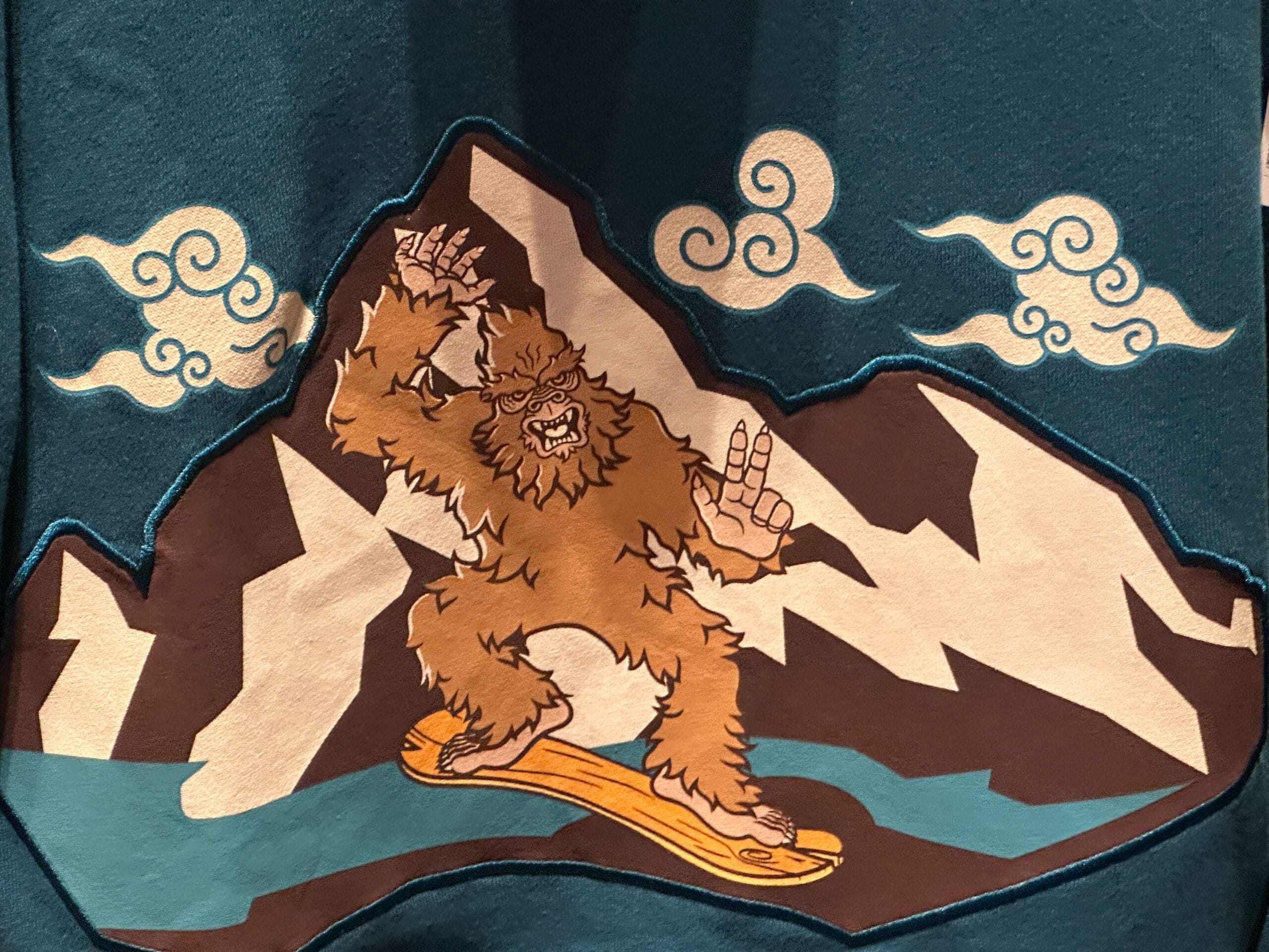 A Surfer Yeti snowboards down a mountain with swirling clouds, echoing Expedition Everest’s thrills at Disney’s Animal Kingdom.