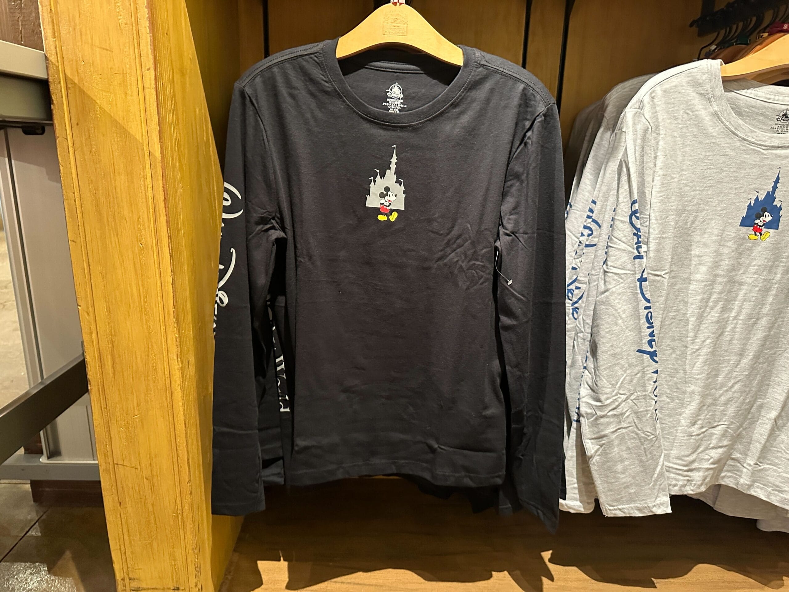 Black long-sleeve shirt with a small Mickey and Cinderella Castle graphic, closely resembling Walt Disney World’s iconic castle.
