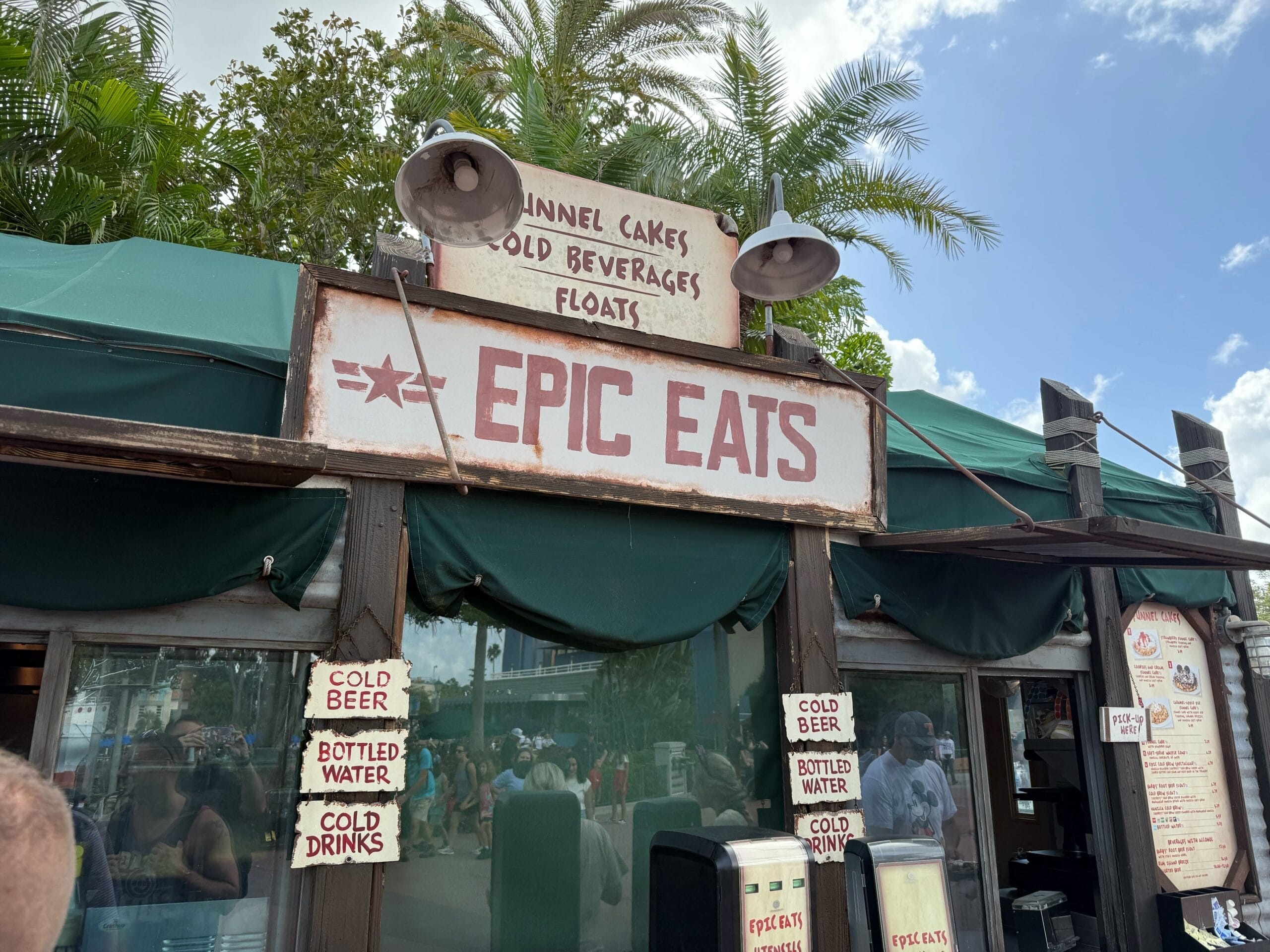 Epic Eats food stand at Disney's Hollywood Studios serves funnel cakes, Epic Cold Brew, and drinks—no castle like WDW's in view.